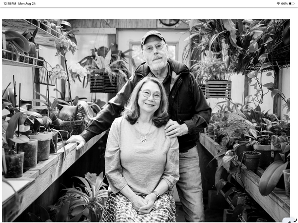 Anne and Dick Schneider in their greenhouse. 