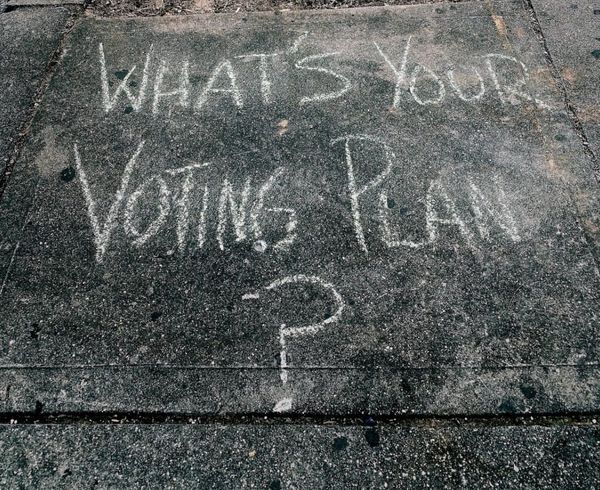 "What's Your Voting Plan?" written in chalk on a sidewalk.