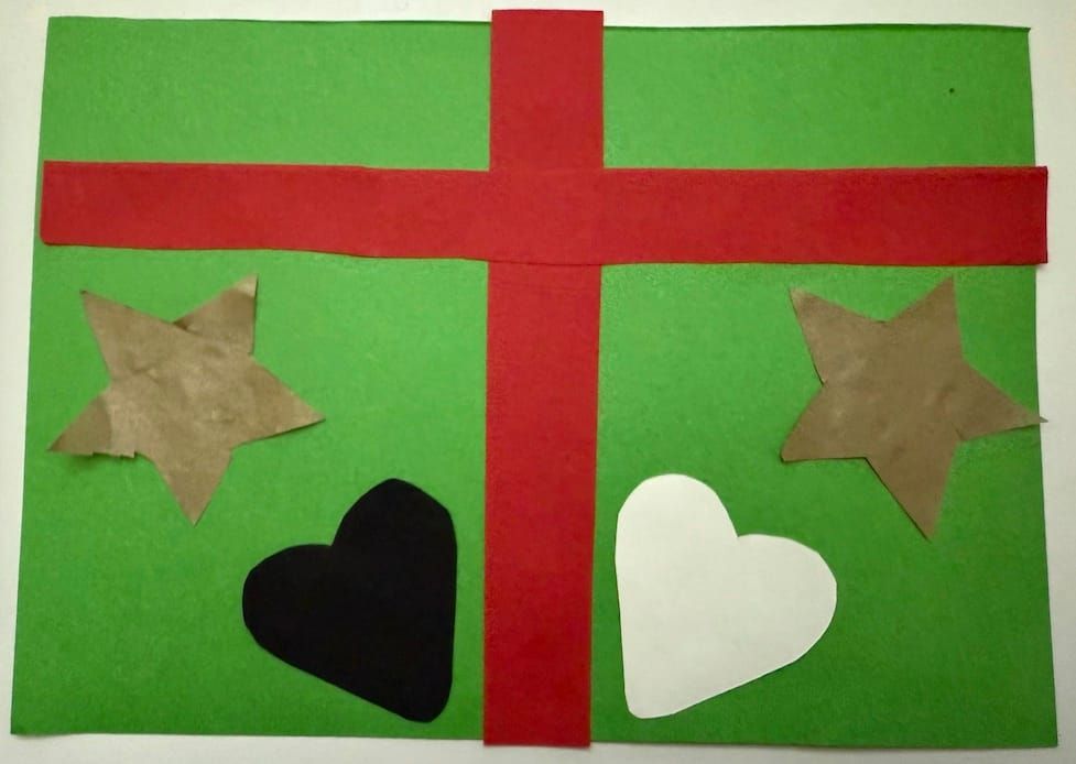 Green rectangle with bright red cross-shaped ribbon. On the left is a gold star shape and a black heart shape. On the right is a white heart shape and gold star shape 