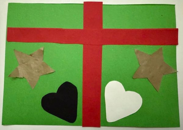 Green rectangle with bright red cross-shaped ribbon. On the left is a gold star shape and a black heart shape. On the right is a white heart shape and gold star shape 