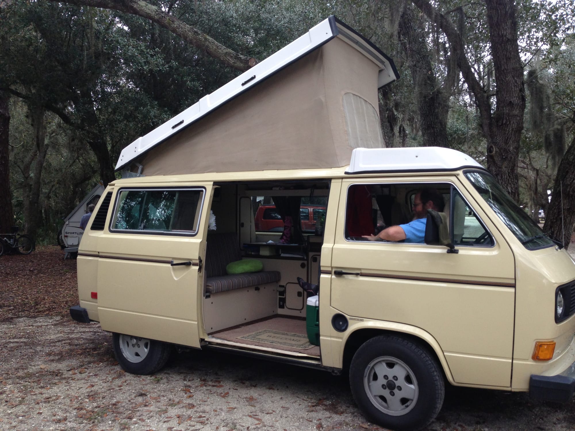 VW camper van with slider door open and top popped