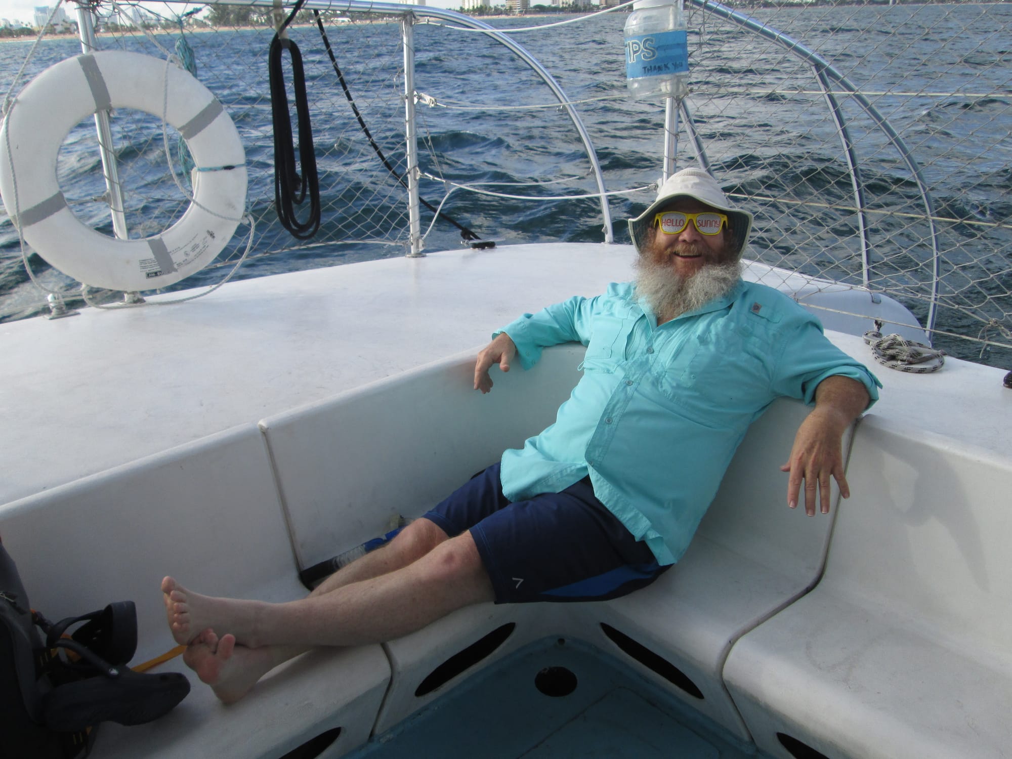 Man with silly glasses relaxing on a sailboat