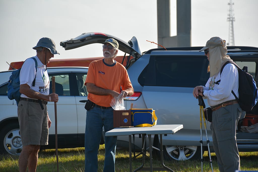 Hikers beside at a table in a parking area