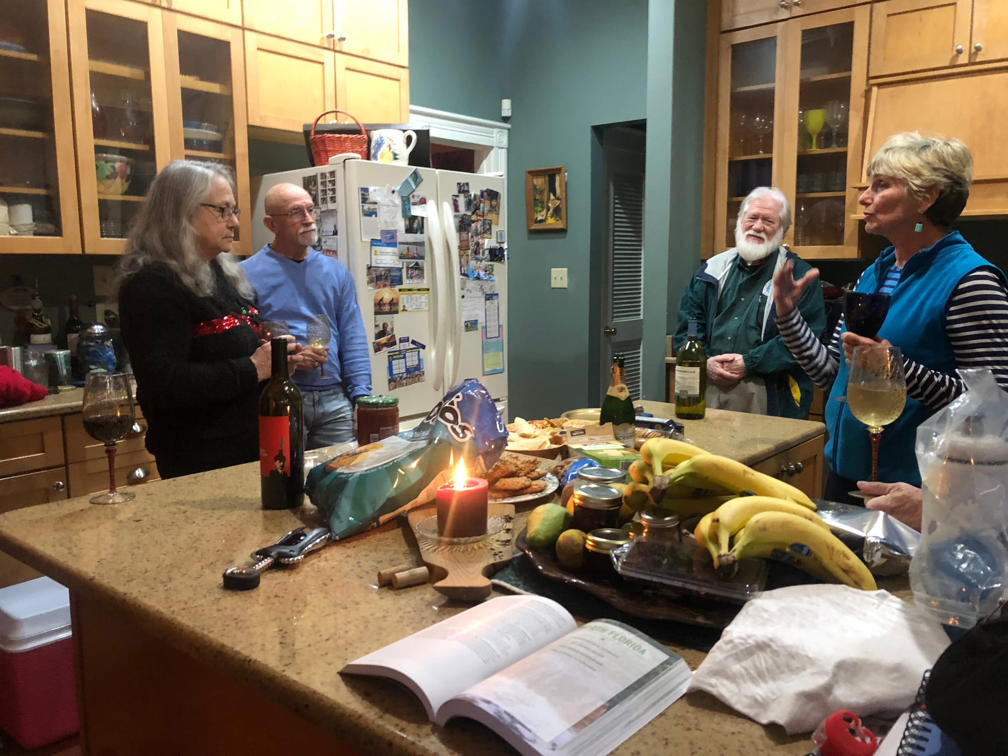 People standing in a kitchen and talking