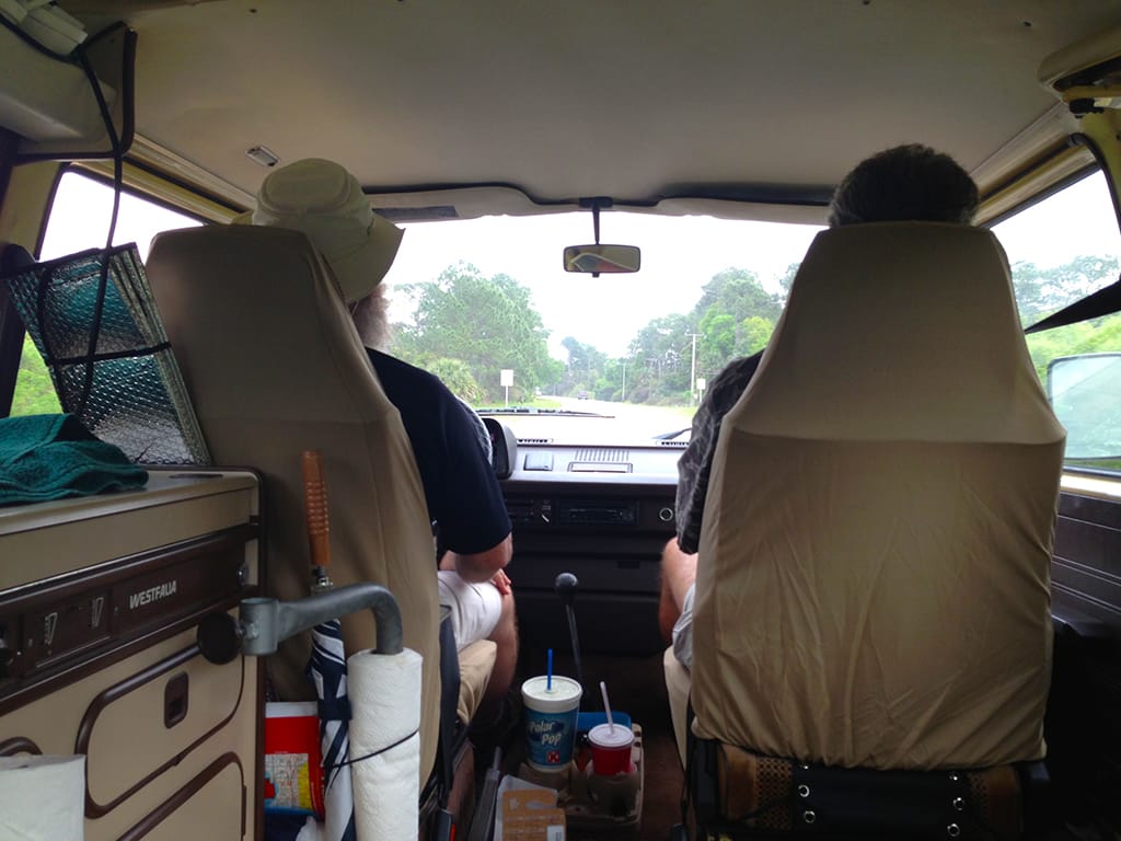 Men sitting in front seats of a Westfalia camper van