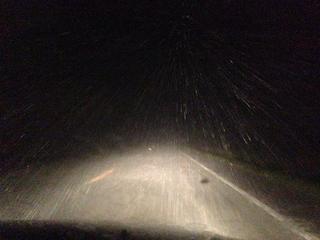 Highway under headlamps in driving rain