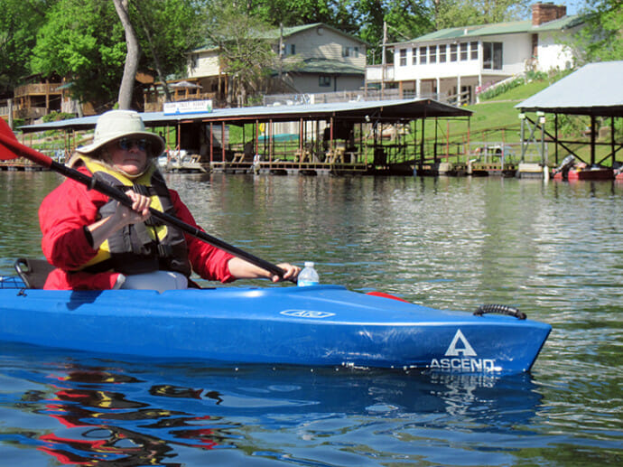 Kayaking past Branson boathouses