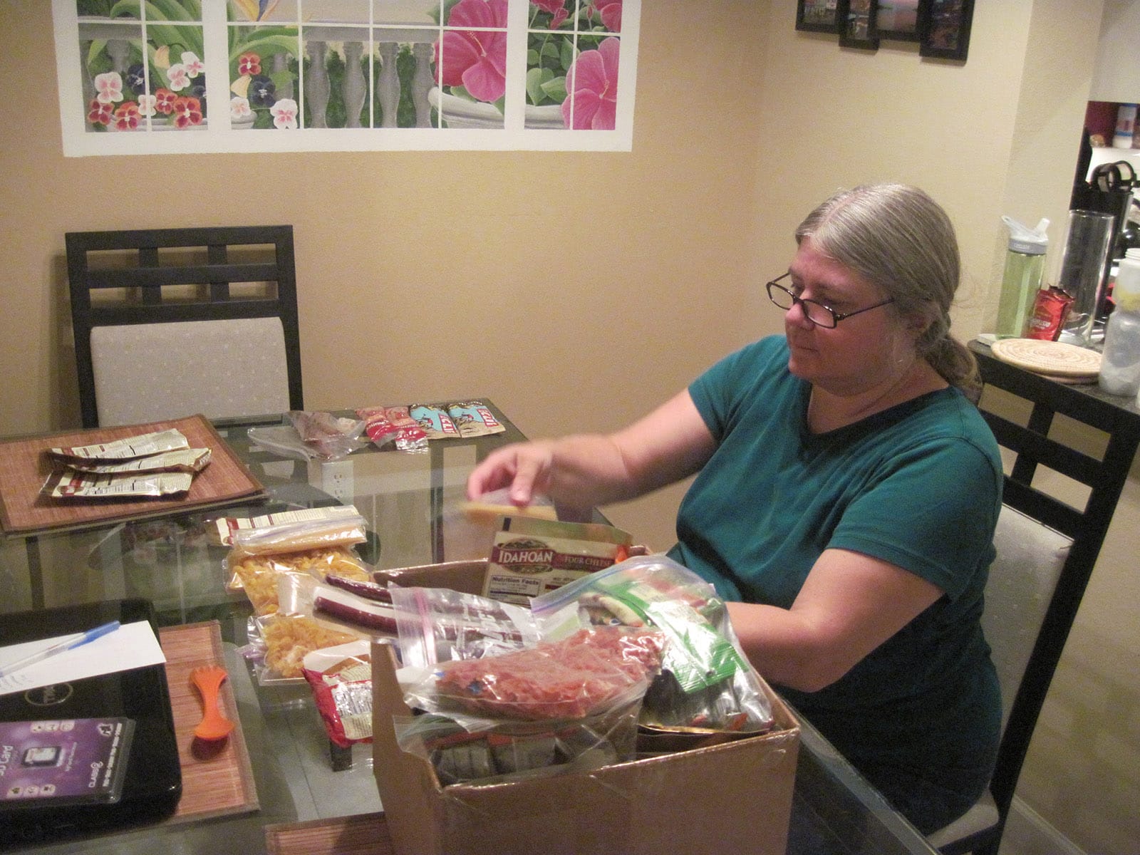 Woman filling boxes with food in packages