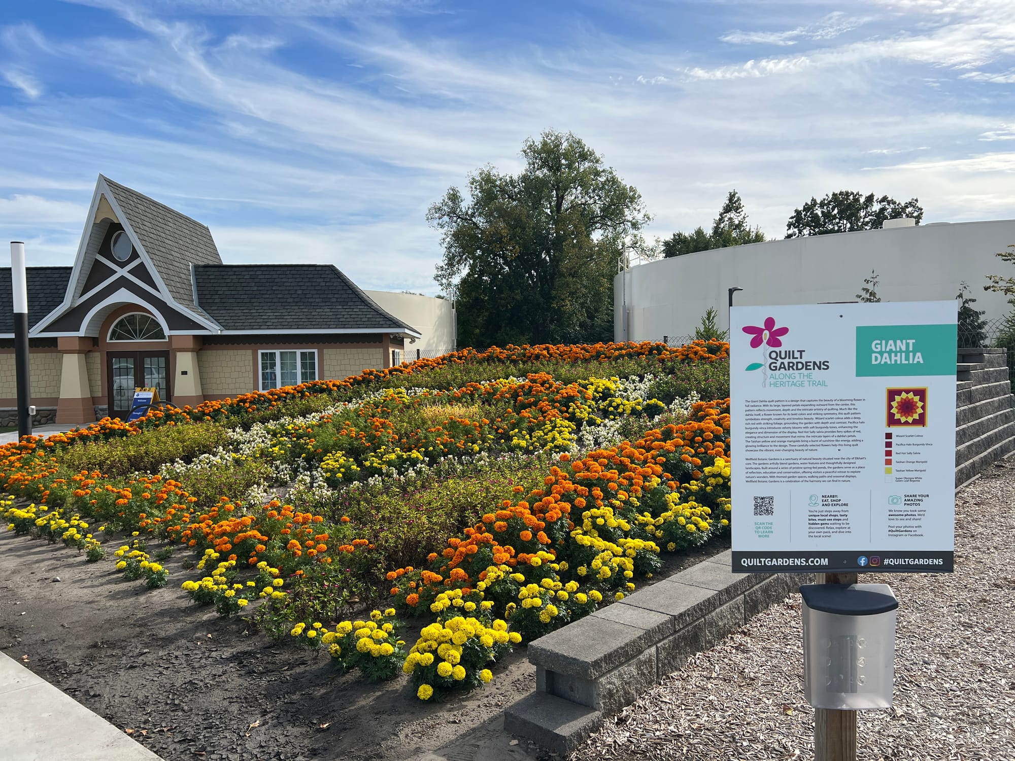 Interpretive sign next to floral quilt of Giant Dahlia