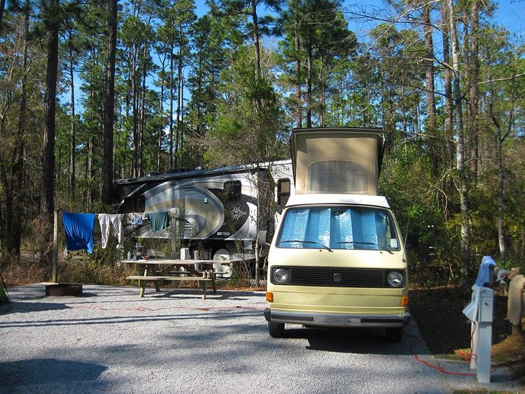 VW camper with RV looming behind it