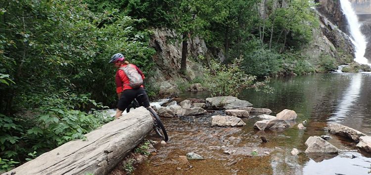 Woman on a mountain bike in shallow water