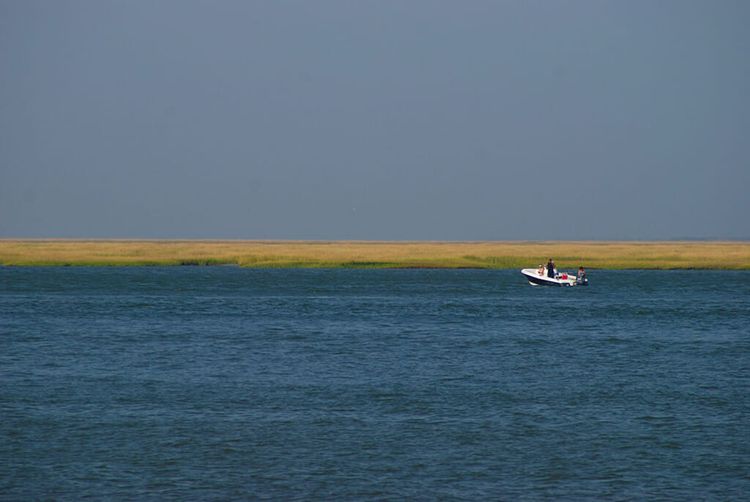 Lone boat in a vast estuary
