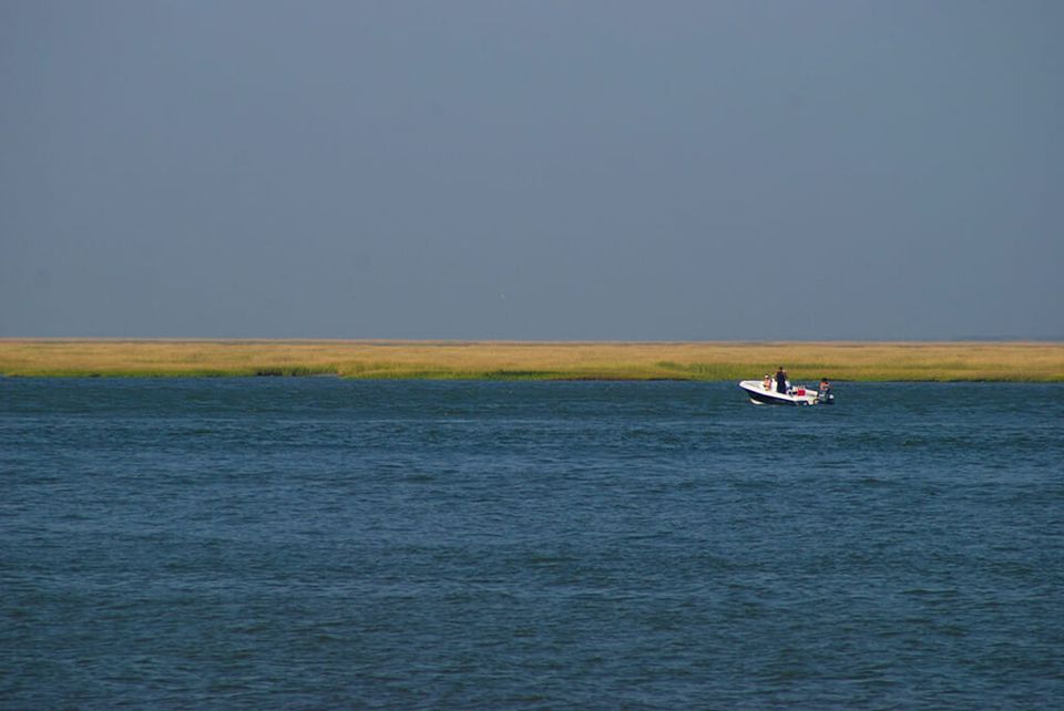 Lone boat in a vast estuary