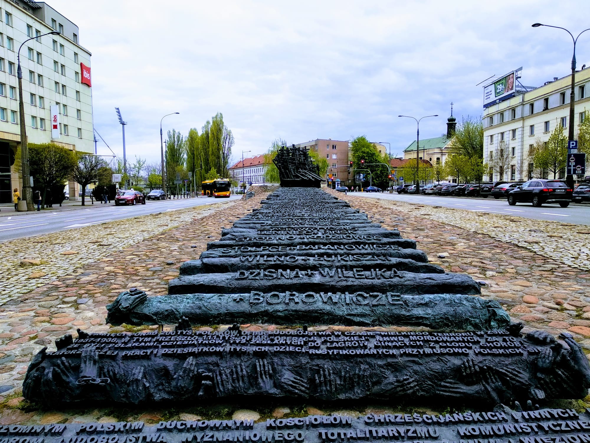 Bronze railway sleepers, some with hands reaching around them, display the names of places from which Polish citizens were deported for use as forced labourers in the USSR.