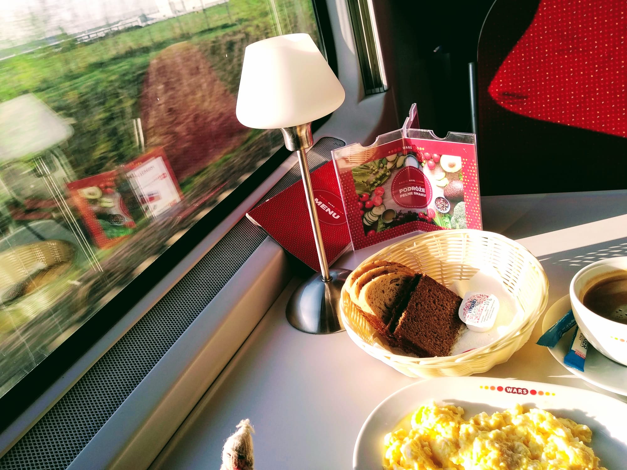 Scrambled eggs and coffee served in a train dining car.