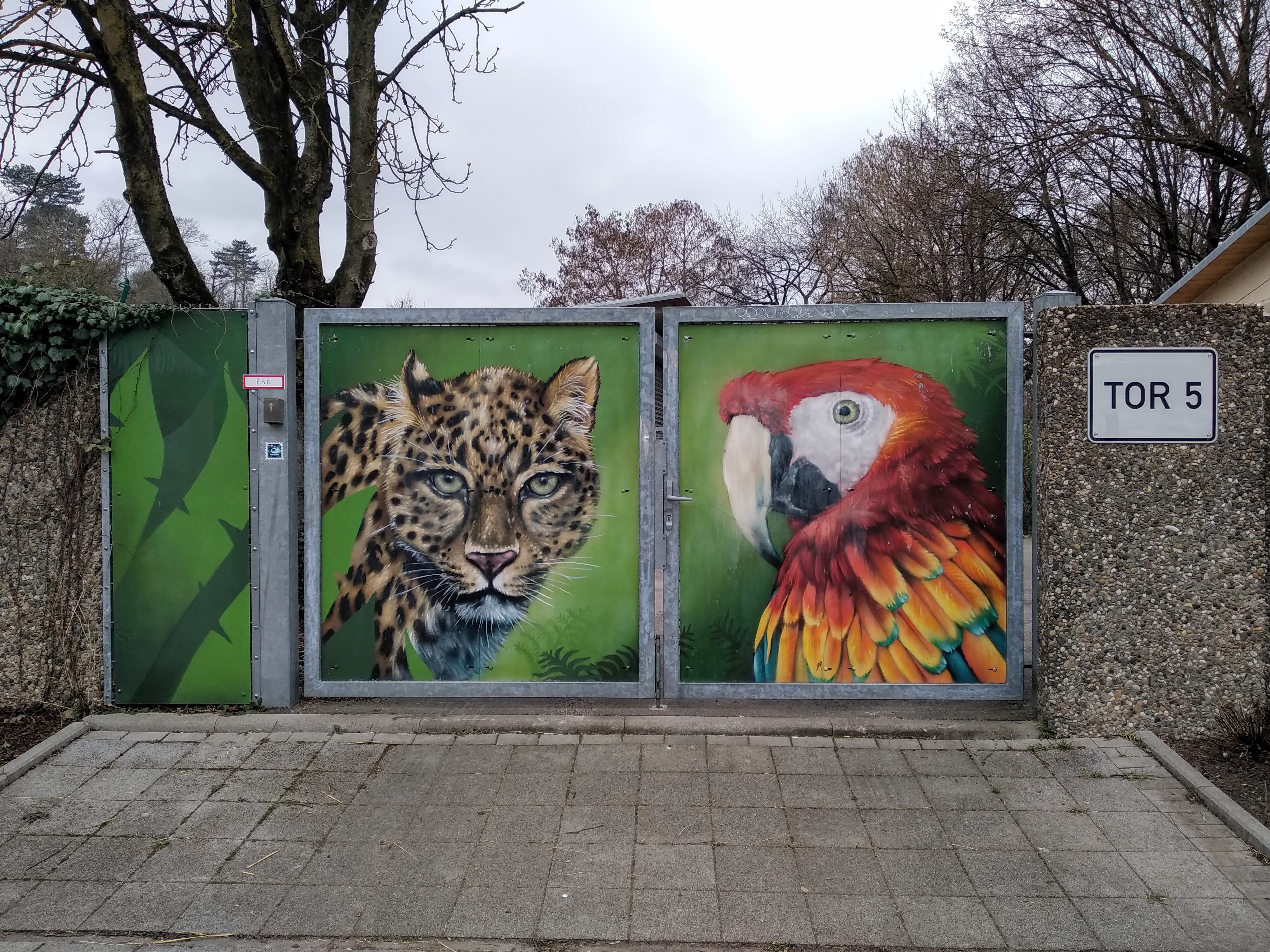 Gateway into the grounds of Karlsruhe zoo, painted with a leopard and a parrot.