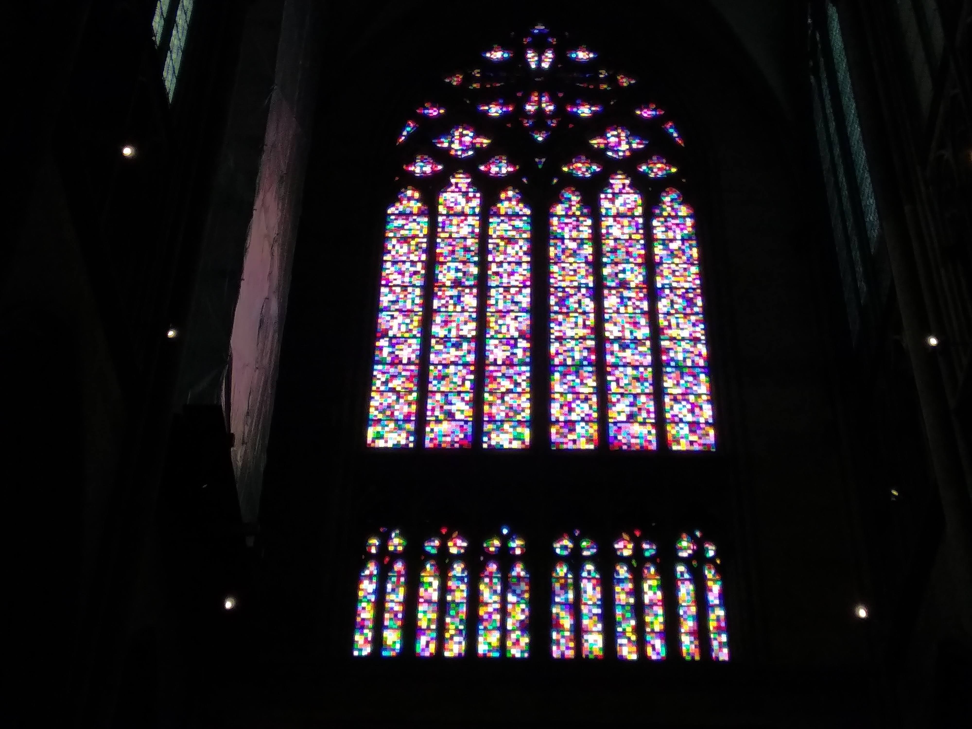 A large stained glass window depicting pixels.