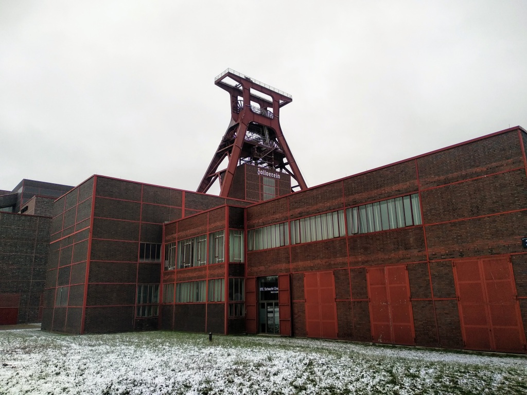 The red head frame and production building of Zollverein's mining museum.