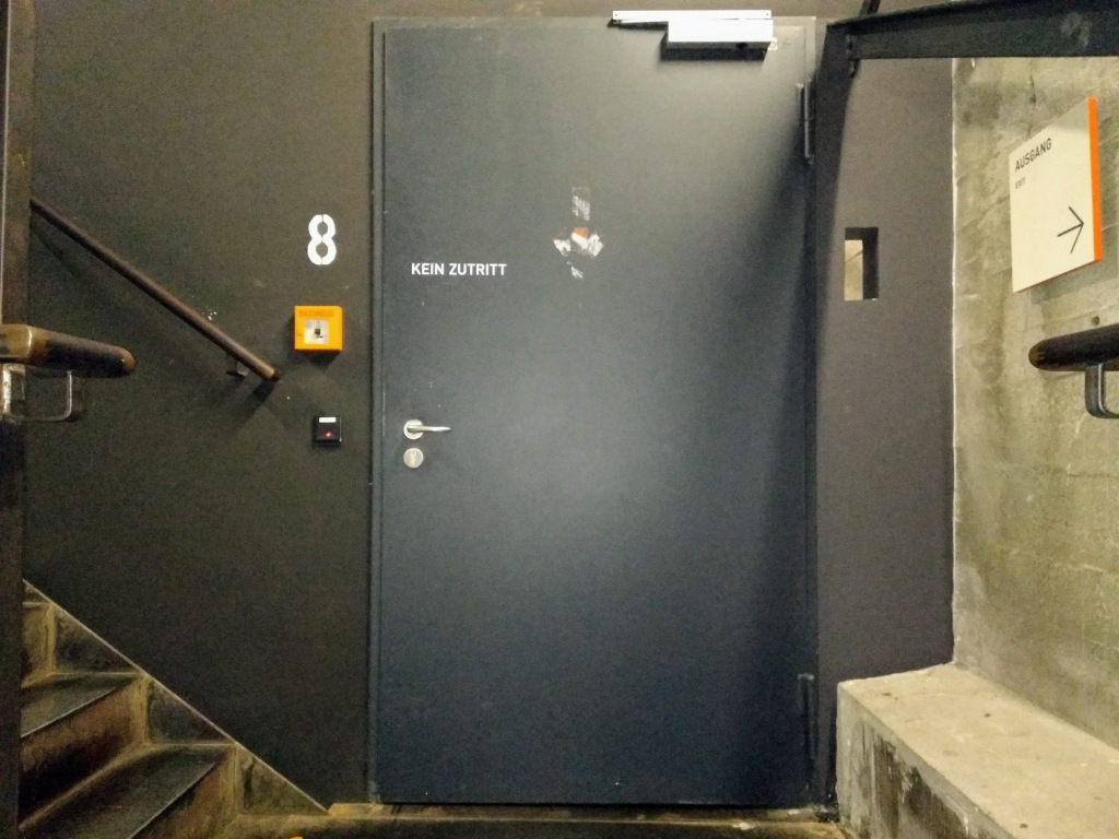 Door 8, a grey metal door, on which is written "Kein Zutritt".