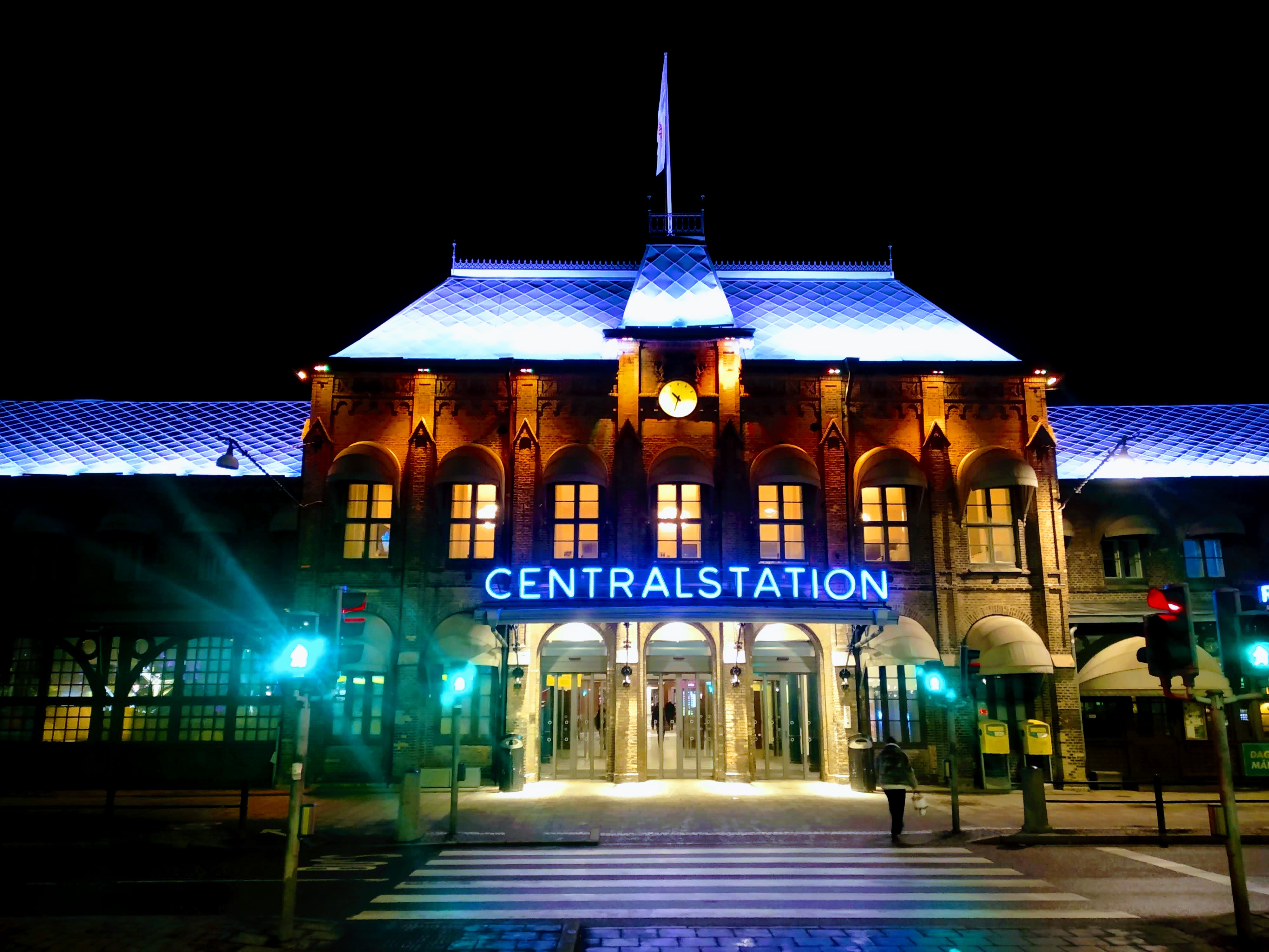 Gothenburg's Centralstation at night. The illuminated word "Centralstation" sits above the main entrance.