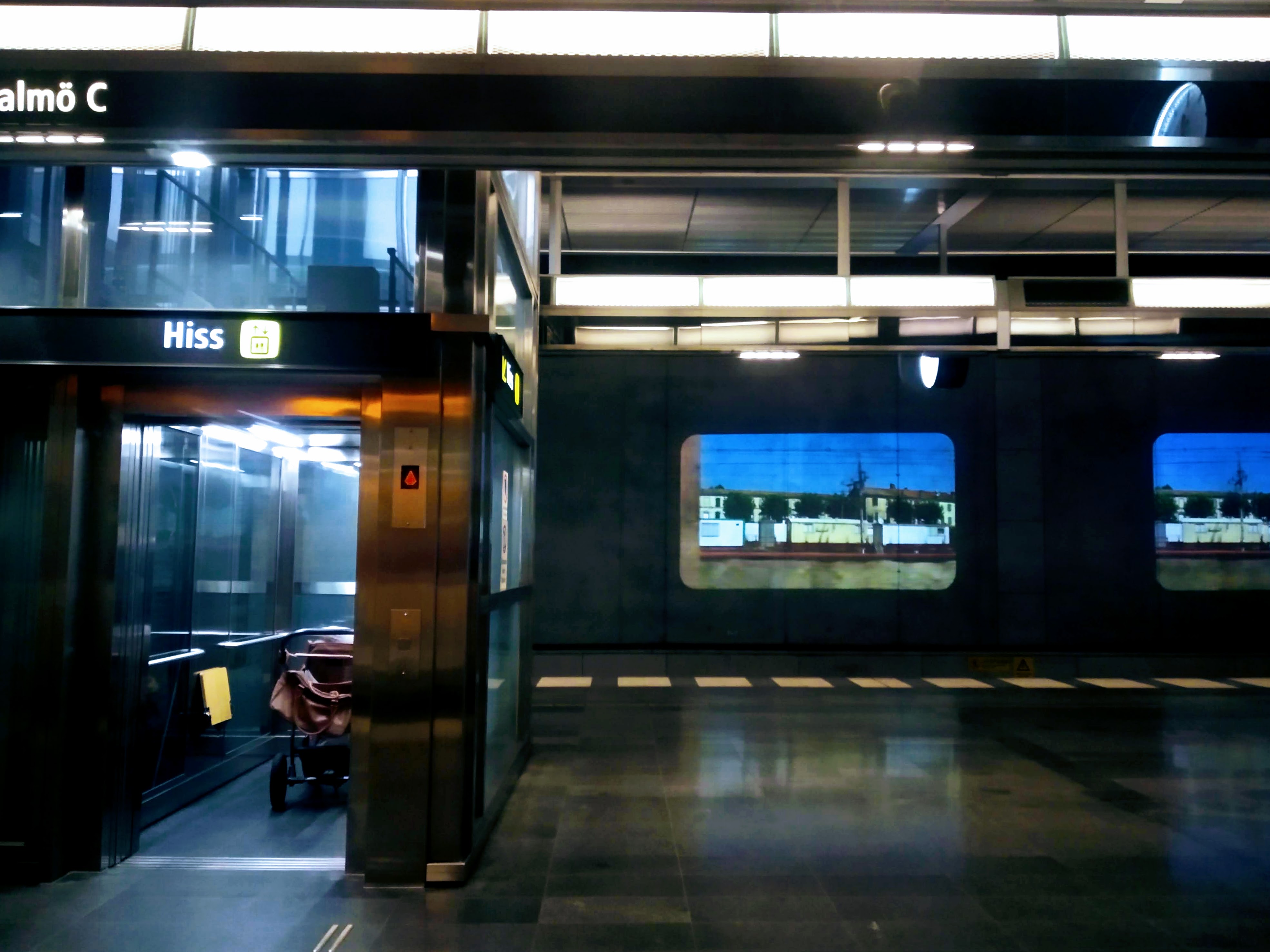 Video filmed from a moving train is projected onto the wall in Malmõ Central.