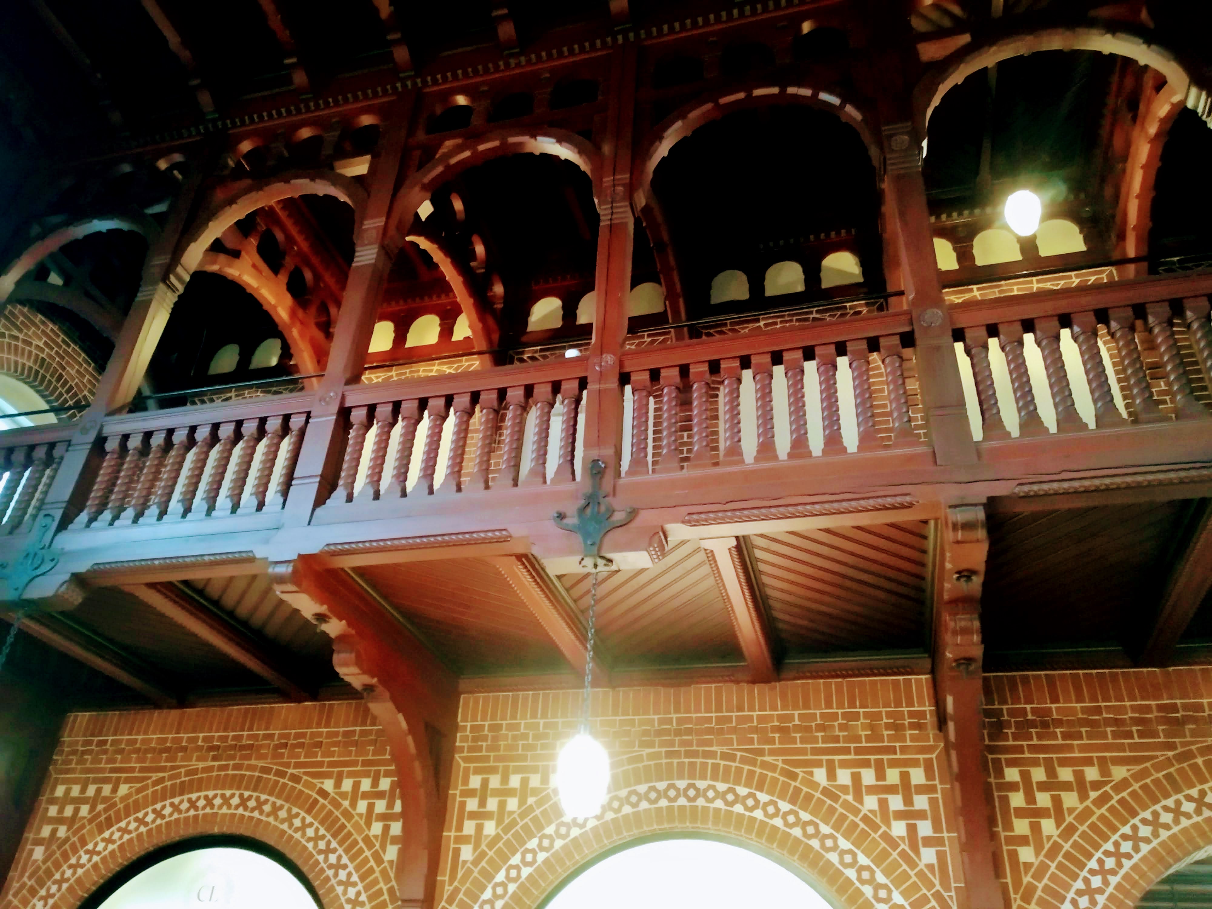 A wooden gallery and hanging lights inside Holstebro station