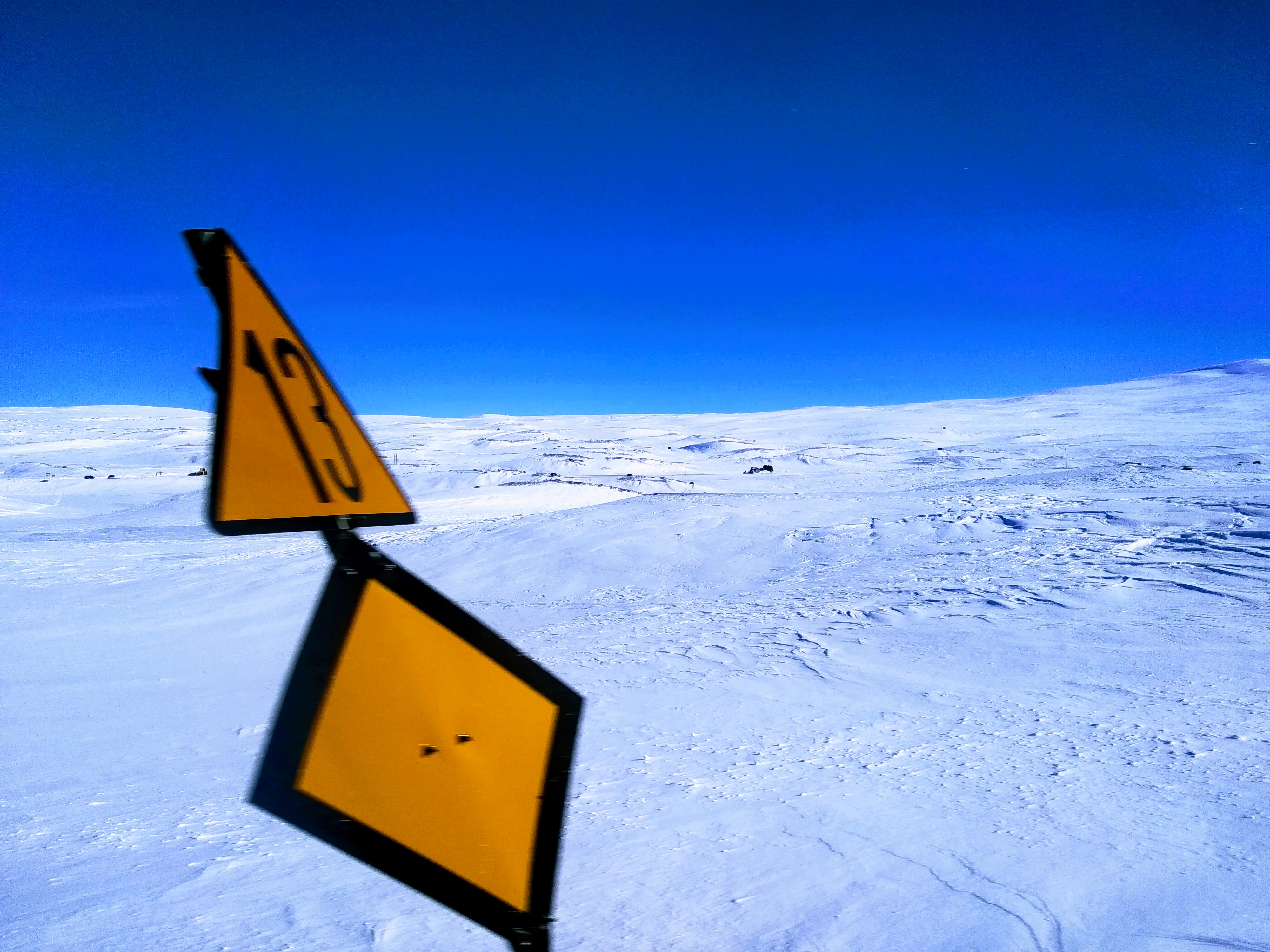 Marker 13 blocking the view of the Arctic Circle station on the line between Trondheim and Bodø.