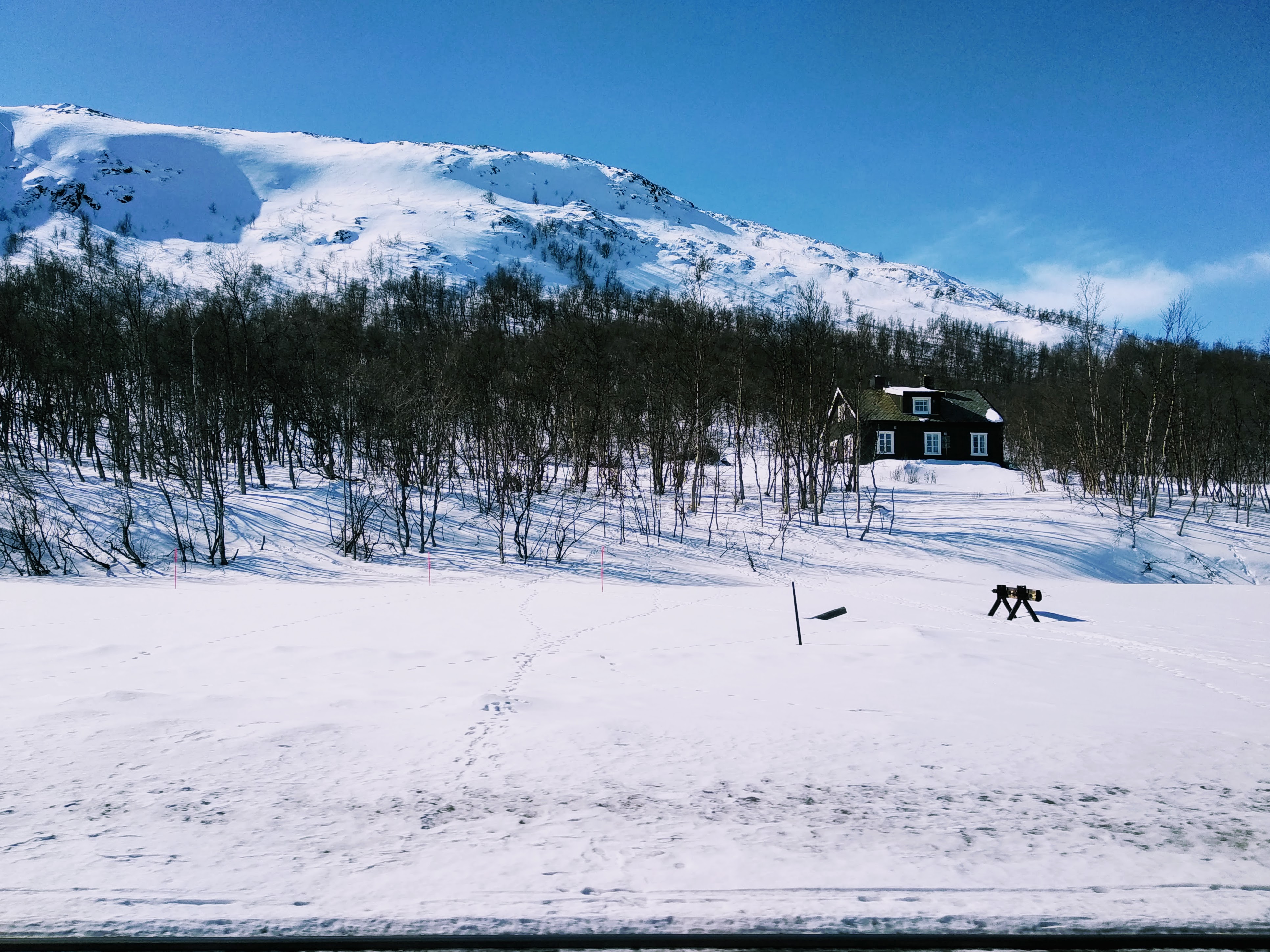 A set of buffers poke through snow at Hjerkinn station.