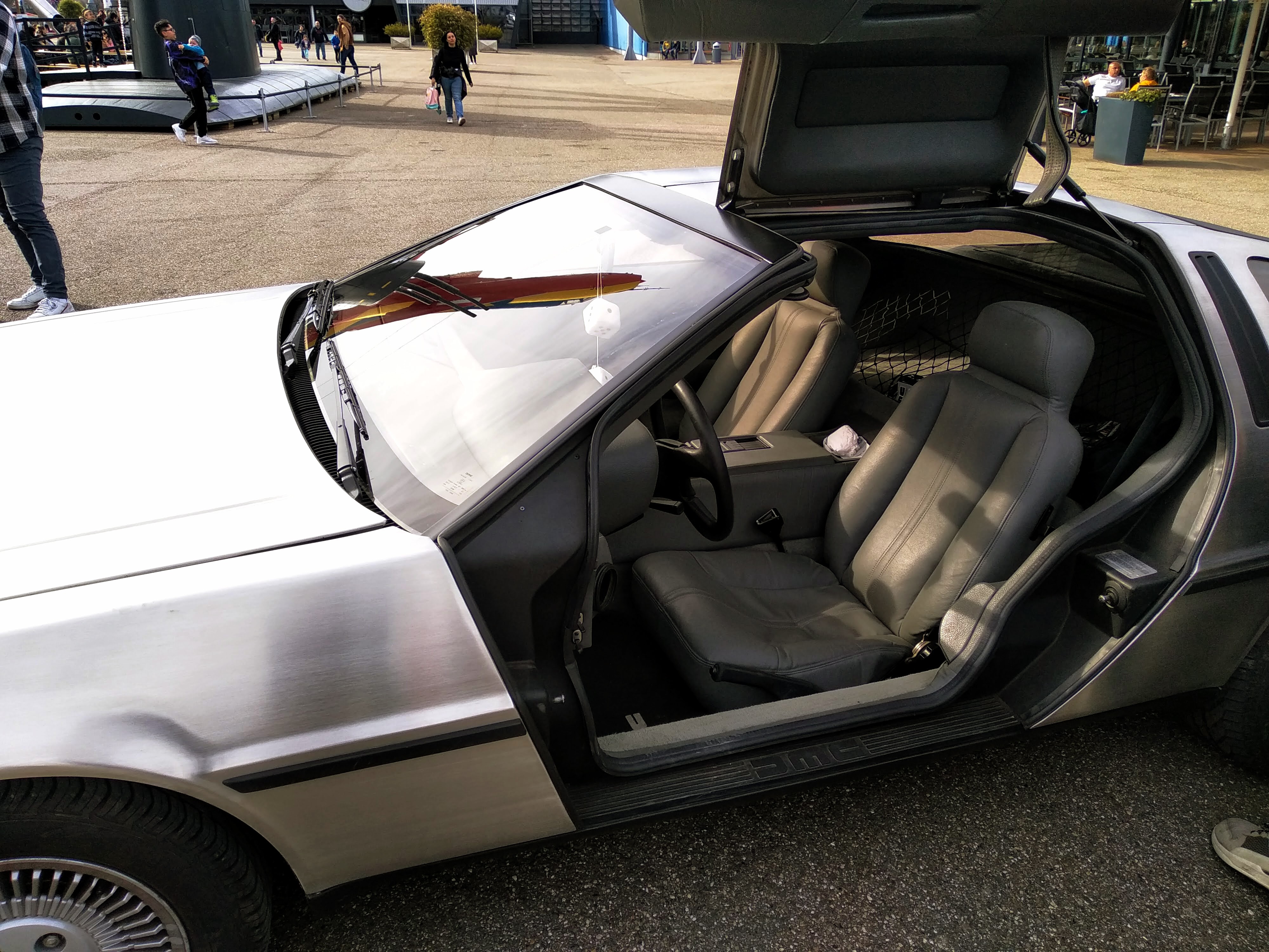 Picture of an open driver's door on a DMC Delorean.