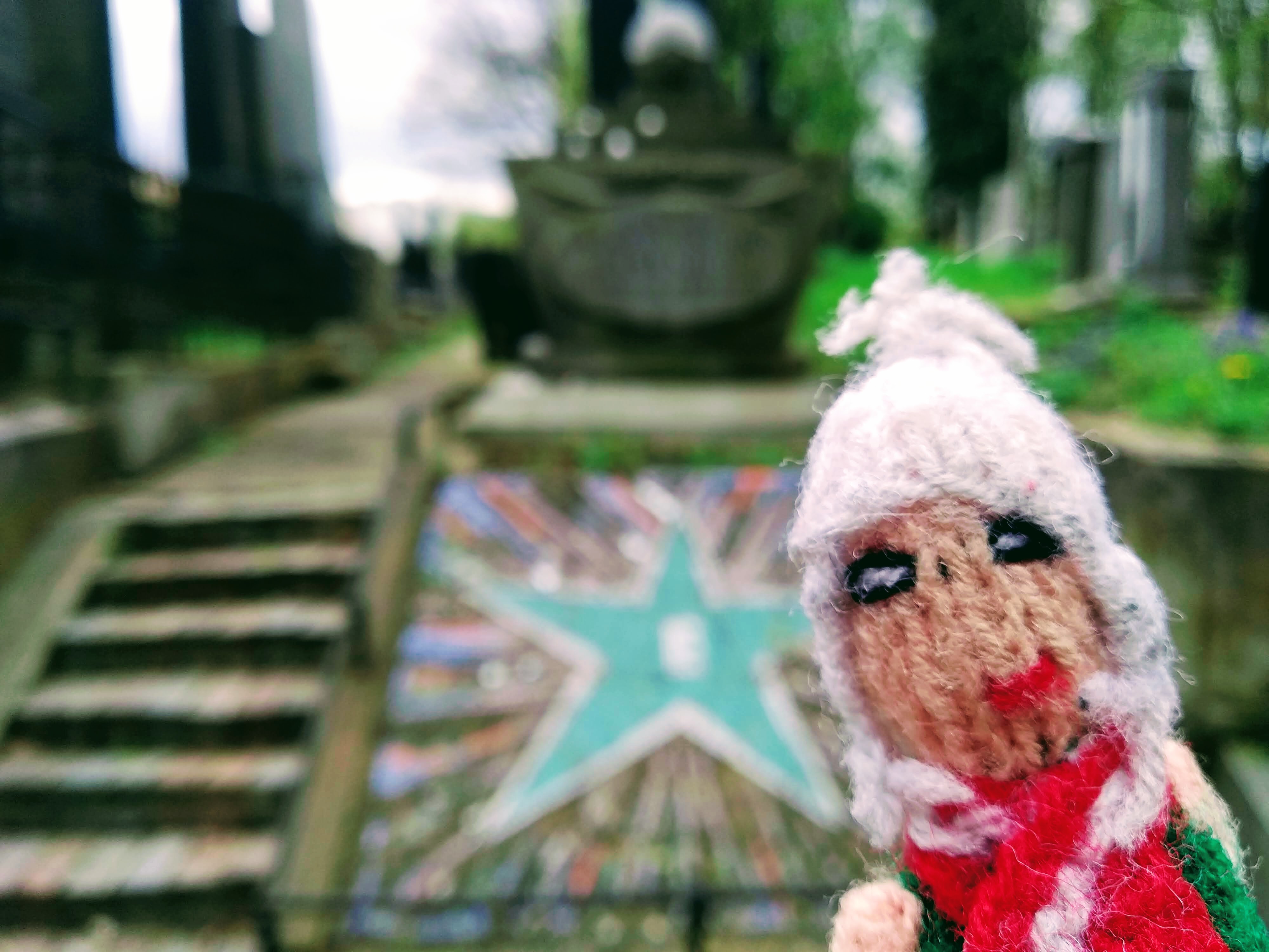 Puppet in front of Zamenhof's tomb in the Jewish Cemetery in Warsaw.