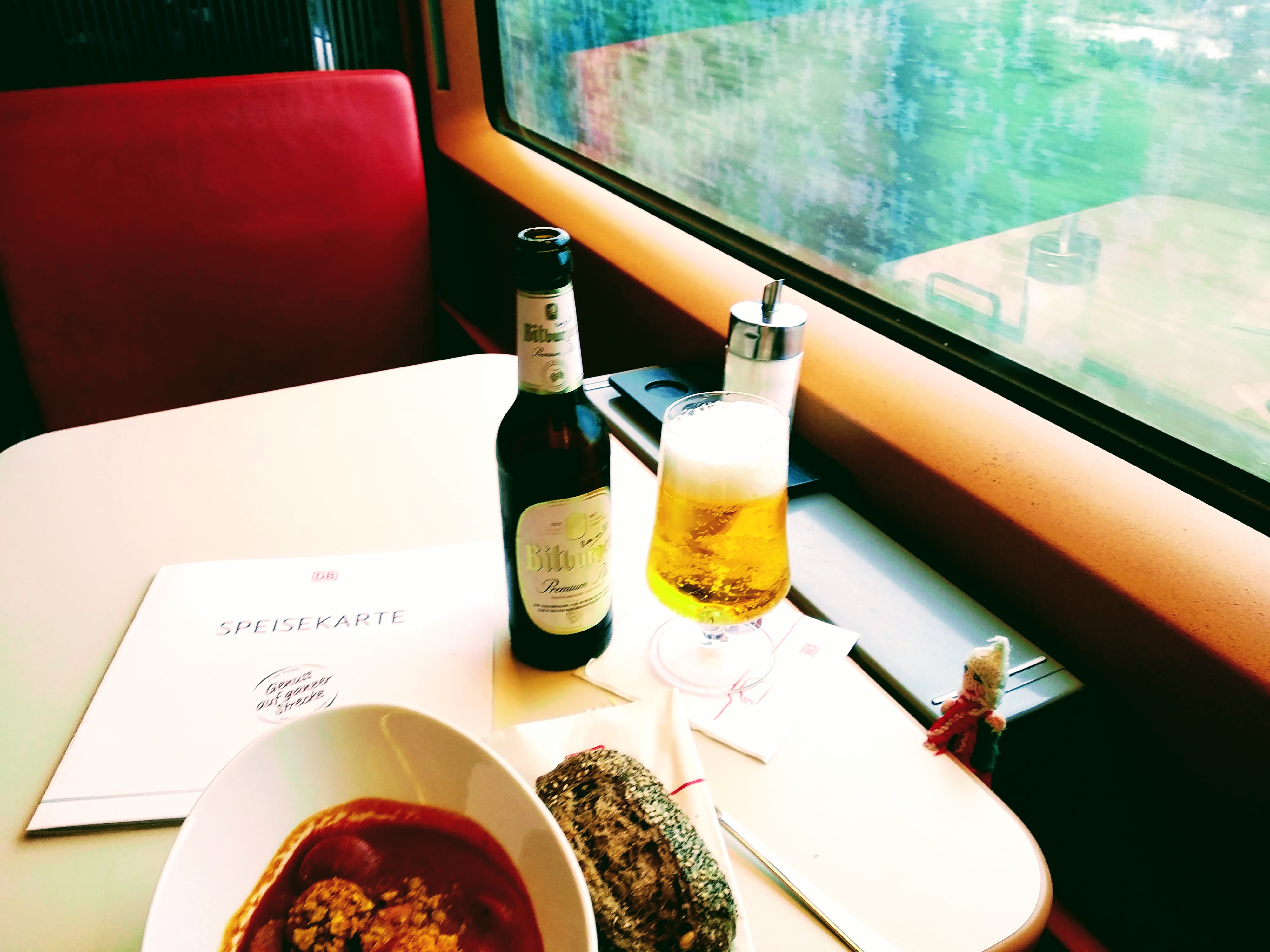 Vegan Currywürst, bread roll, Bitburger, Puppet. All on a train together.