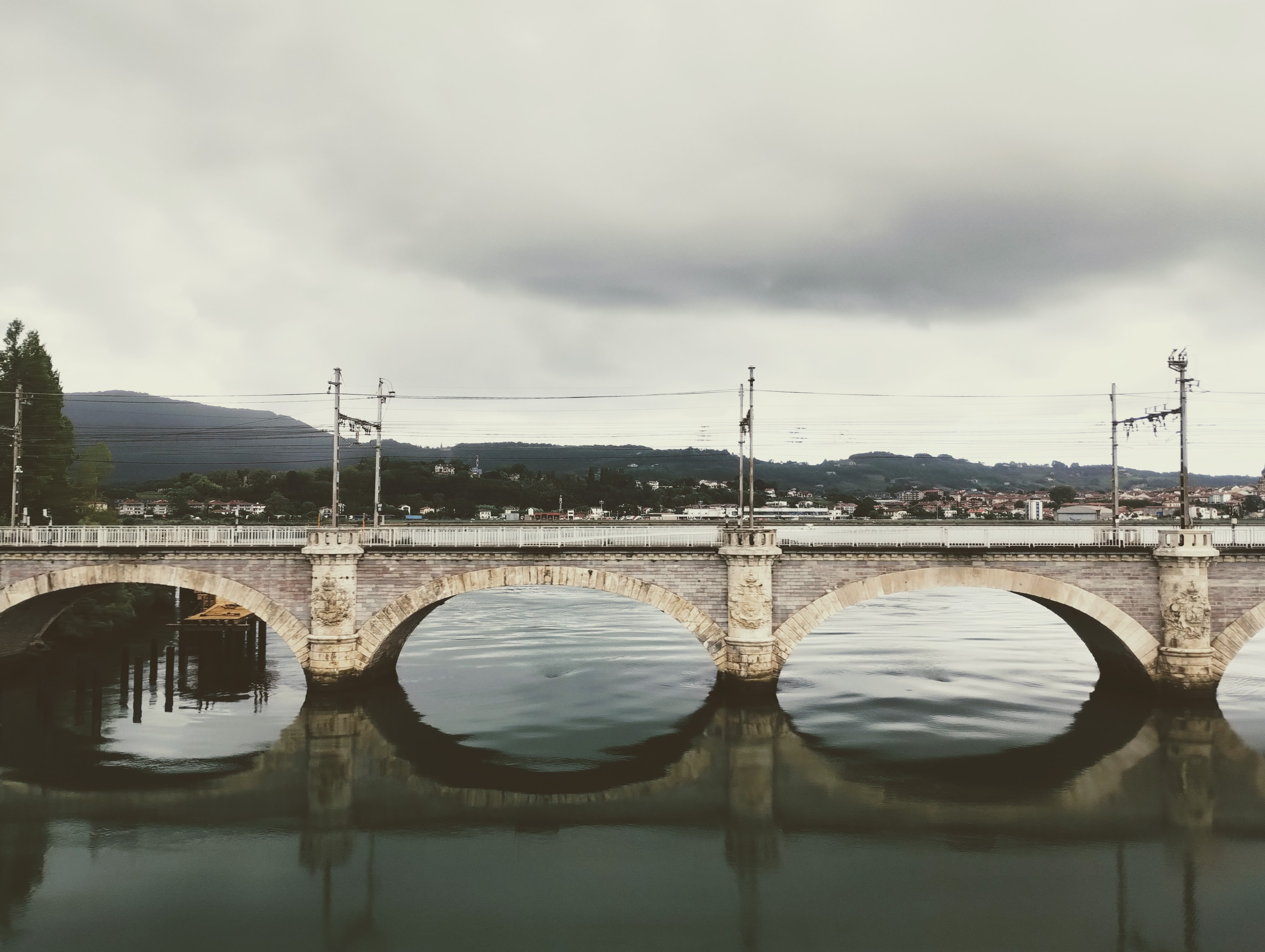 Three arches of the vaulted stone railway bridge crossing the Bidassoa River