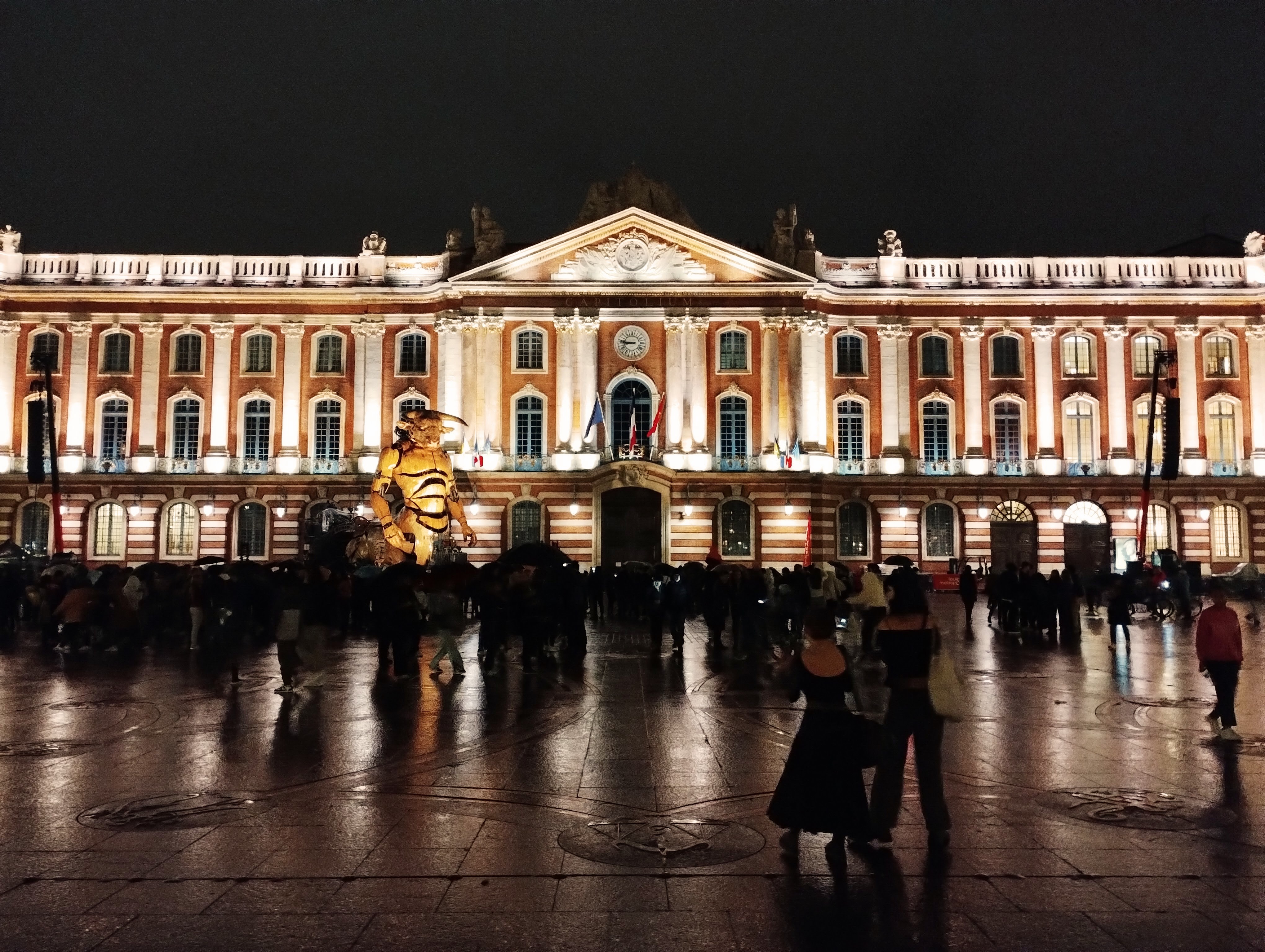 A giant mechanical minotaur thrills the crowds in front of the the magnificent red and white façade of the Capitole in Toulouse.