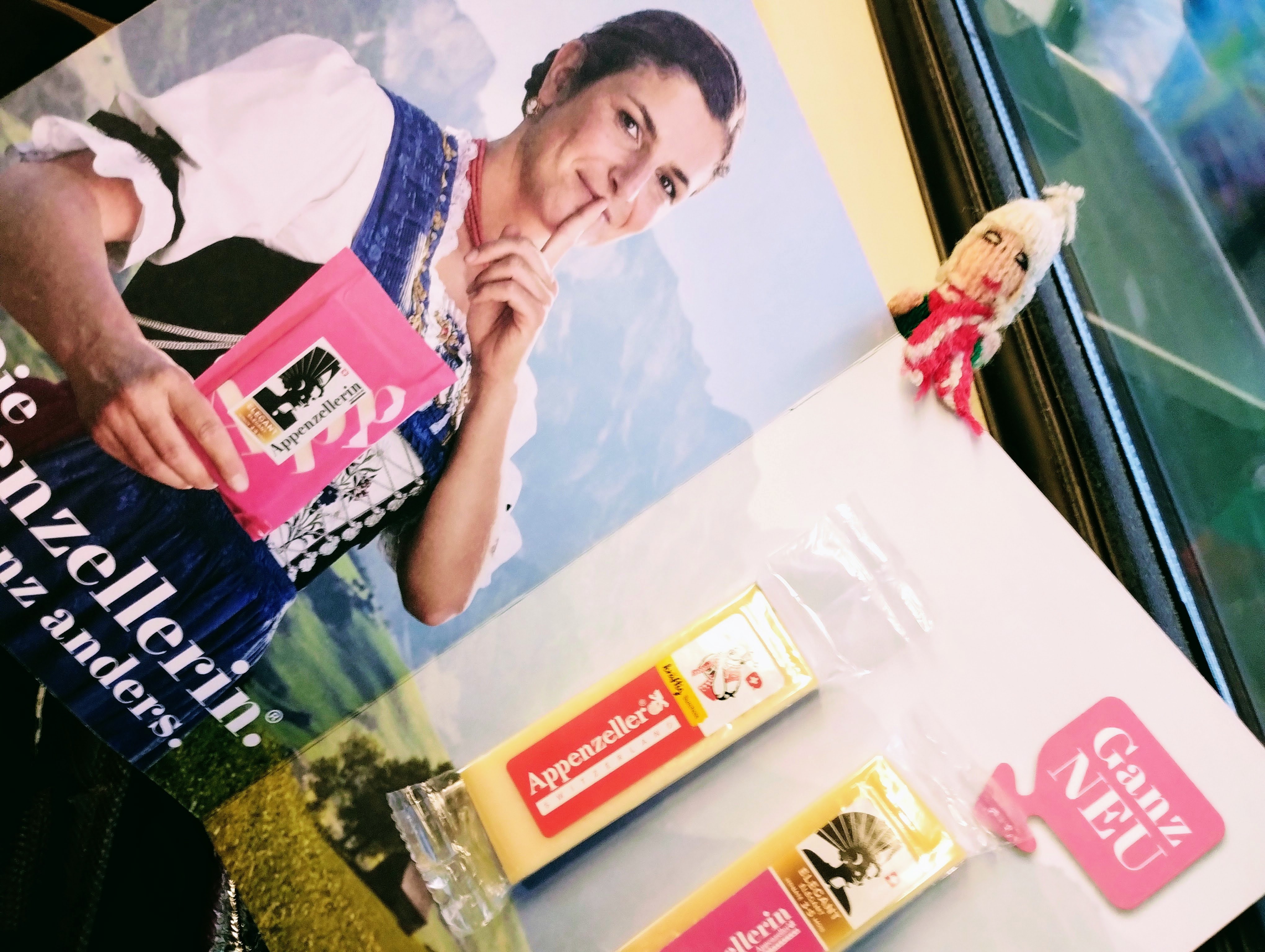A promotional leaflet containing two samples of Appenzeller cheese, and a finger puppet eager to try it.