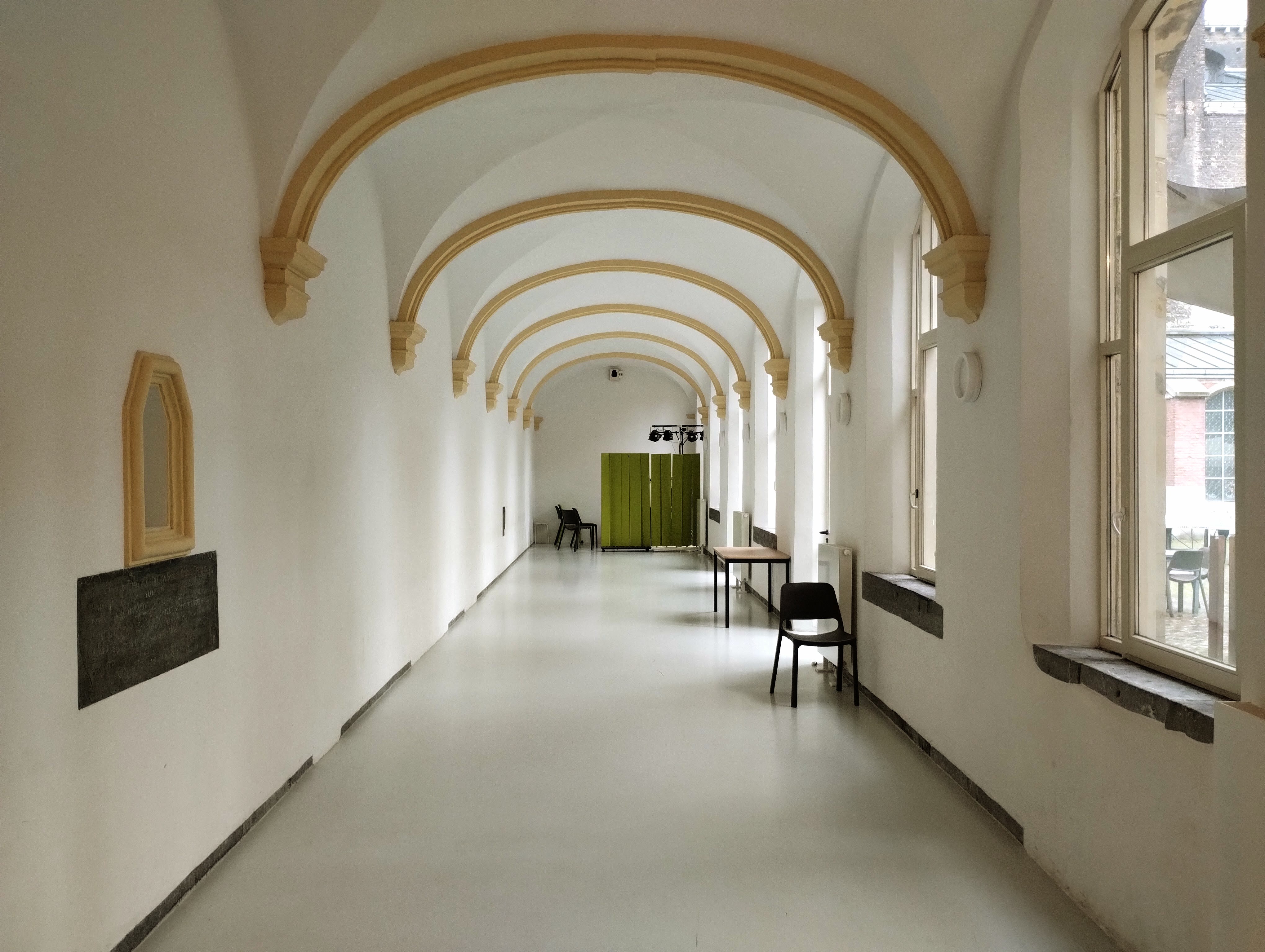 What was once one of the cloisters is now a bright white passageway with chairs and tables.