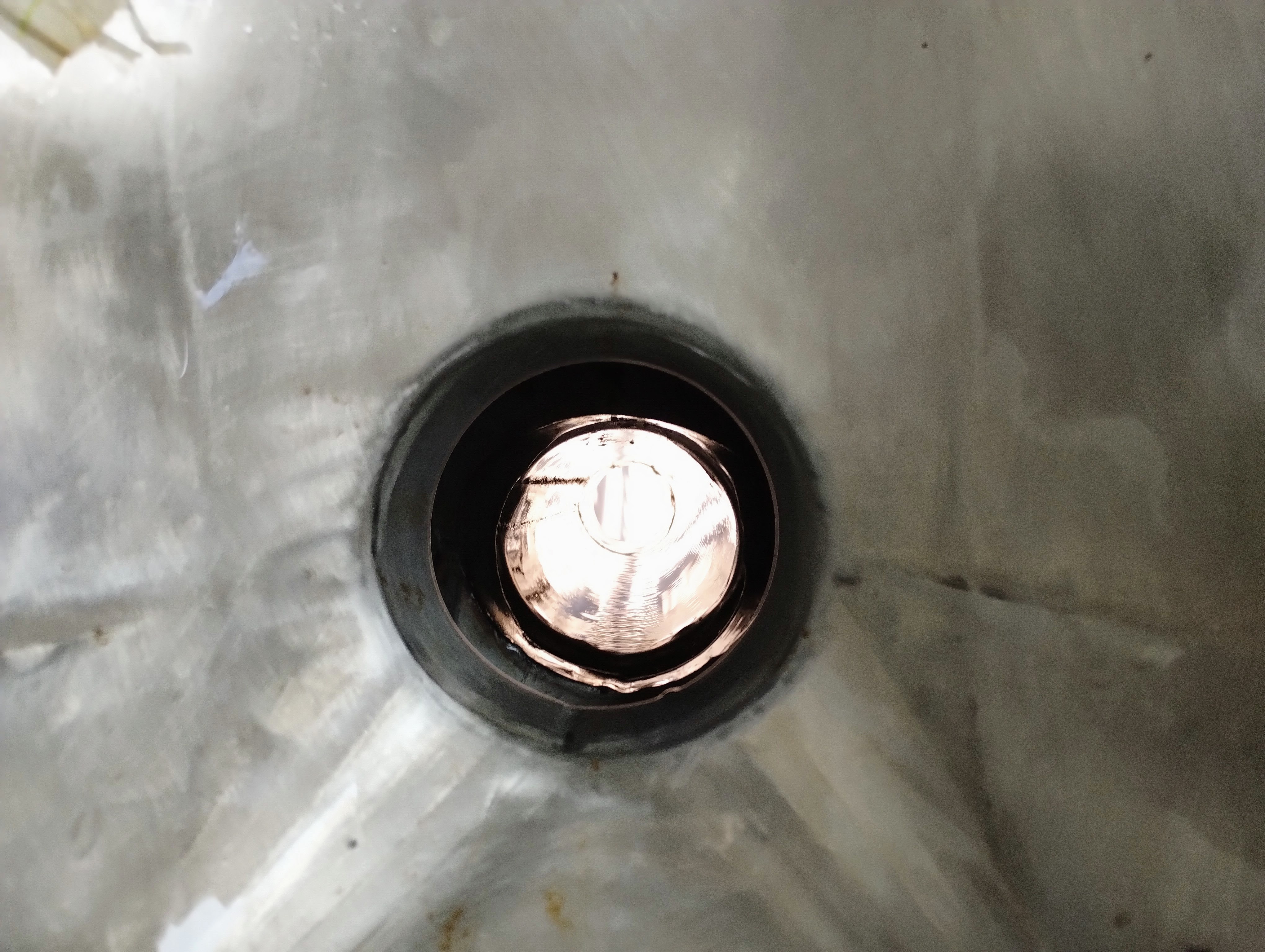 A view down the open pipe connected to a toilet on a Moroccan train.