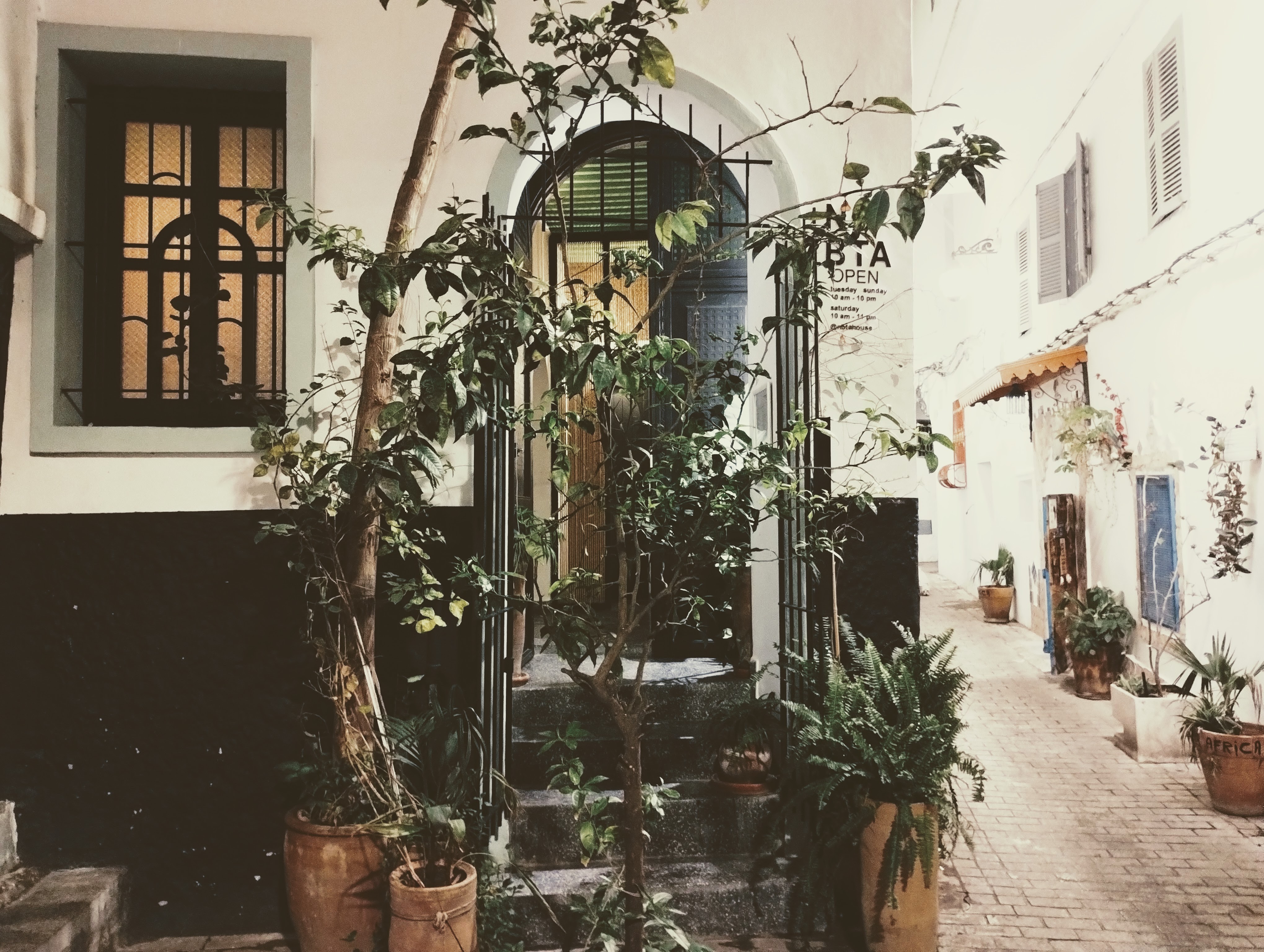 An open door at the top of some steps leads into a restaurant.