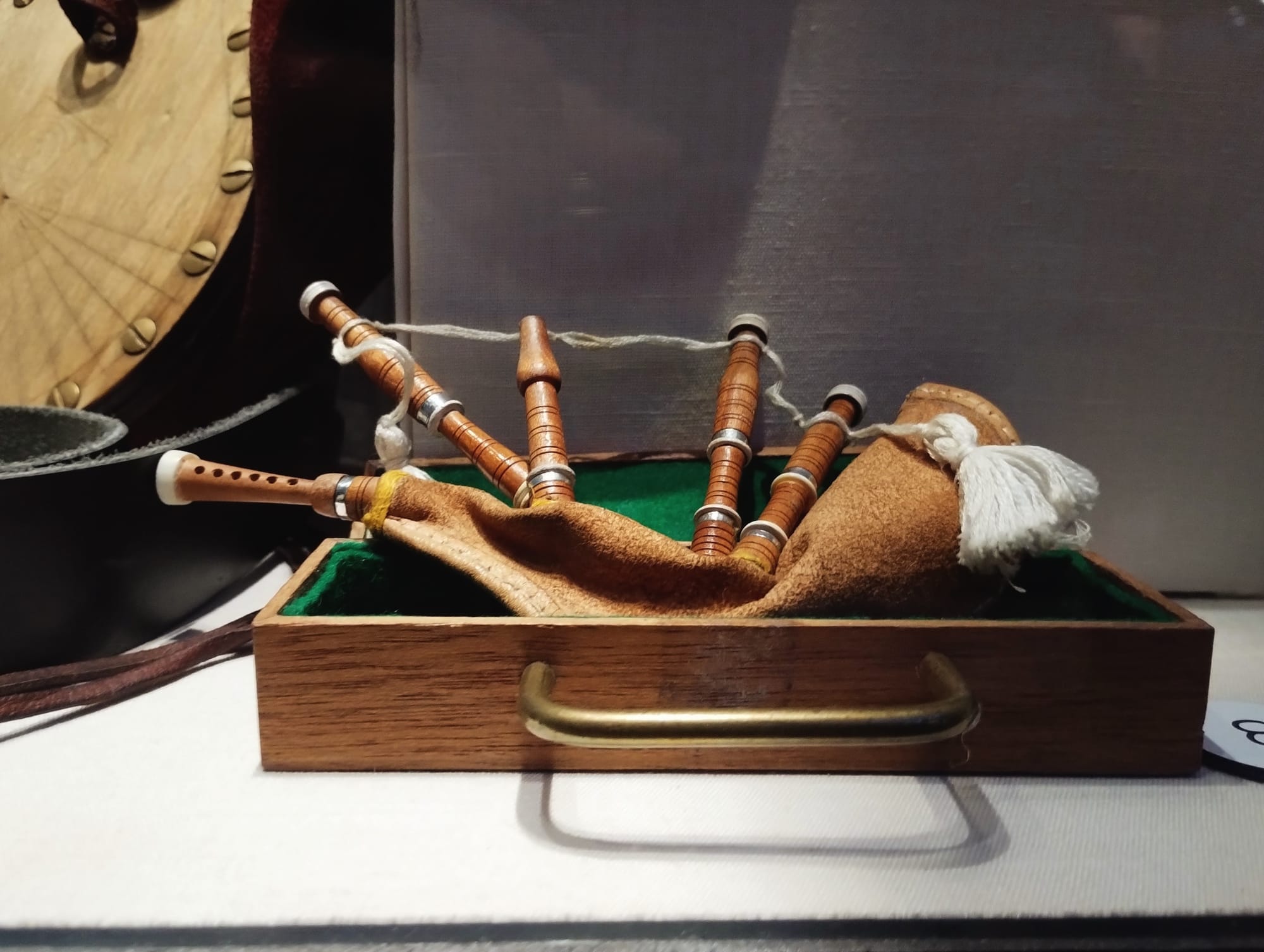 A photograph of a tiny set of bagpipes.