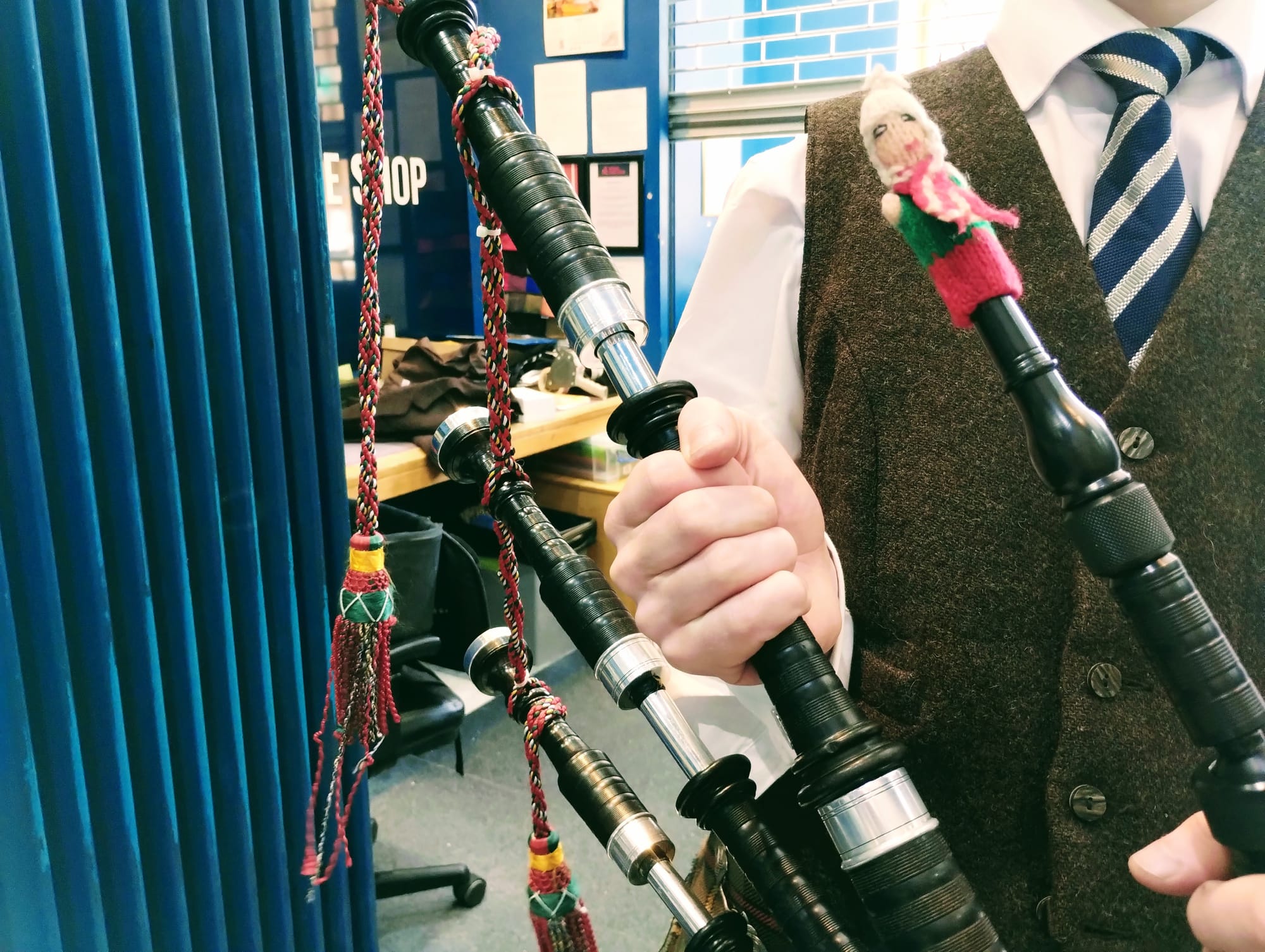 Finger puppet playing the bagpipes.