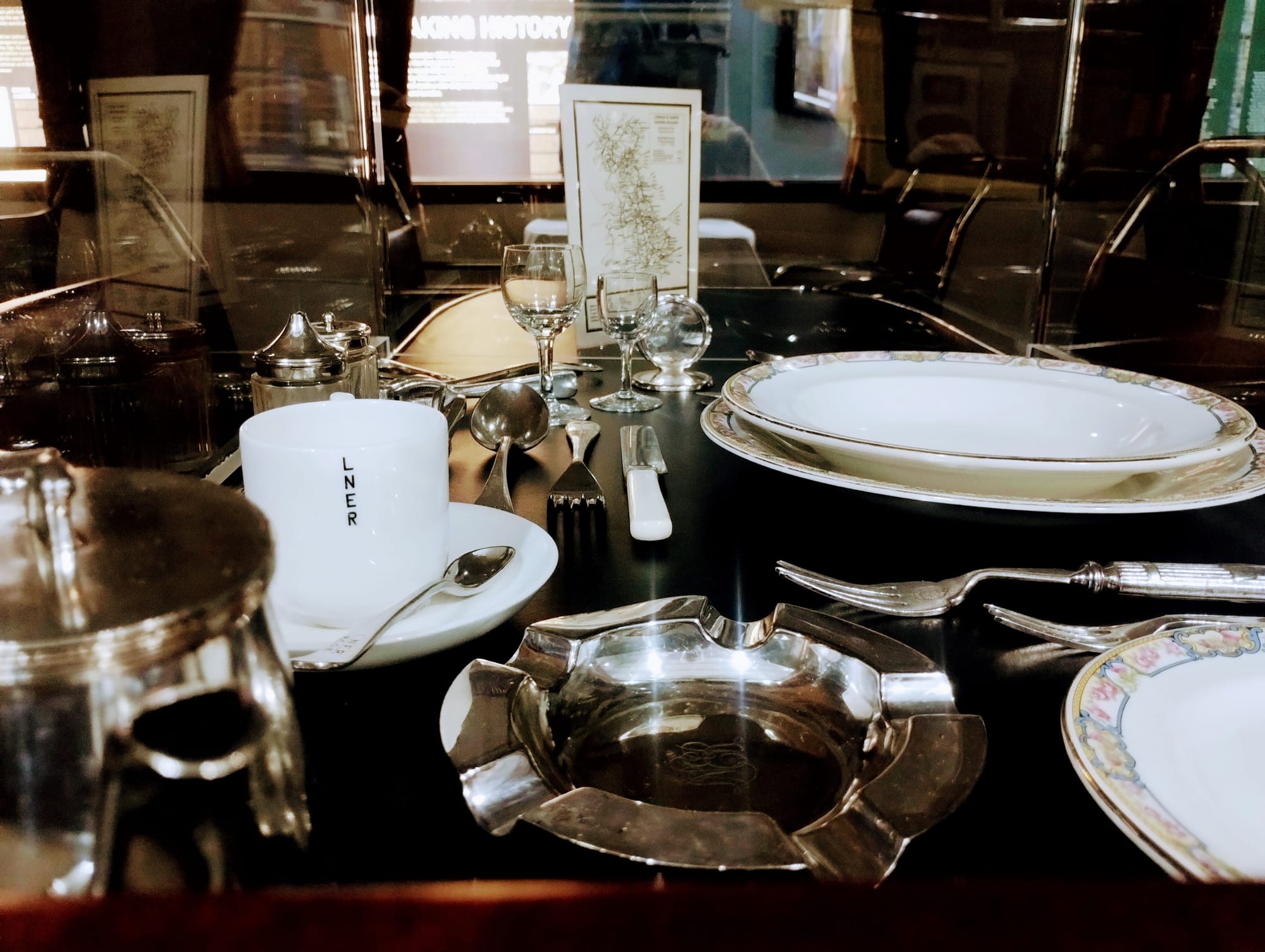 Flying Scotsman dining car table, laid for service with china and cutlery.