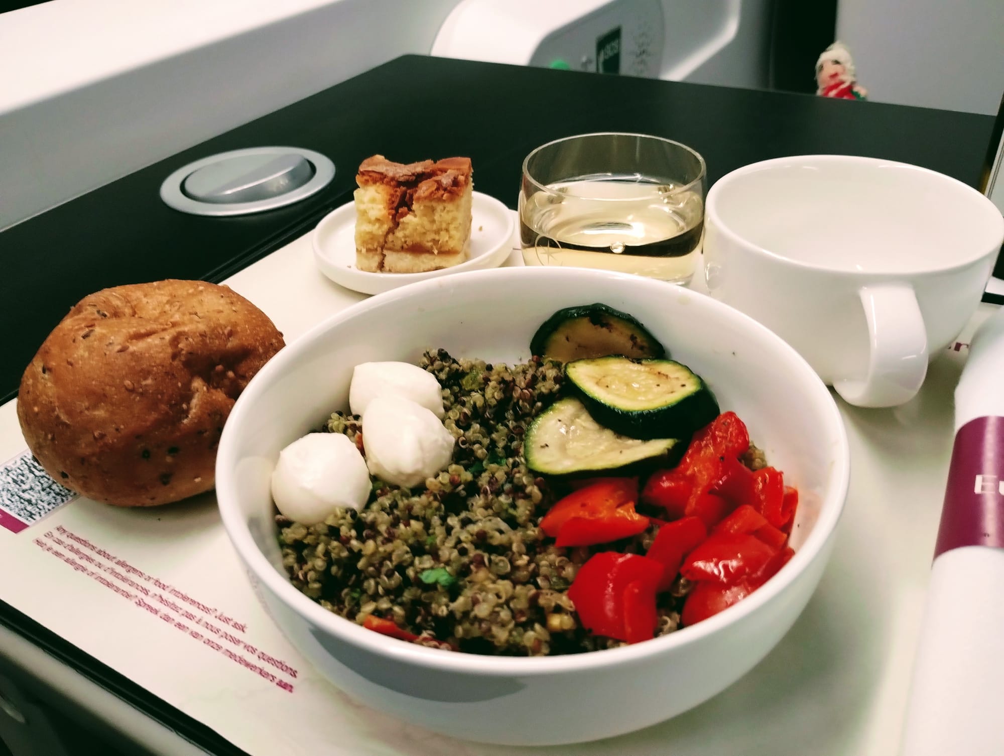 Finger puppet observes a tray of food and wine.