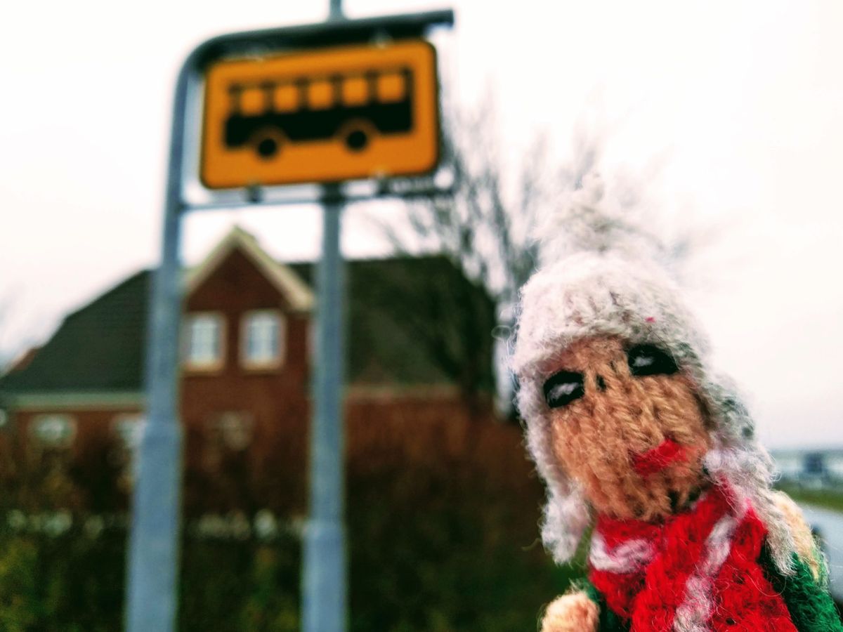 Finger puppet eagerly waiting for a bus in Thyholm, Denmark.