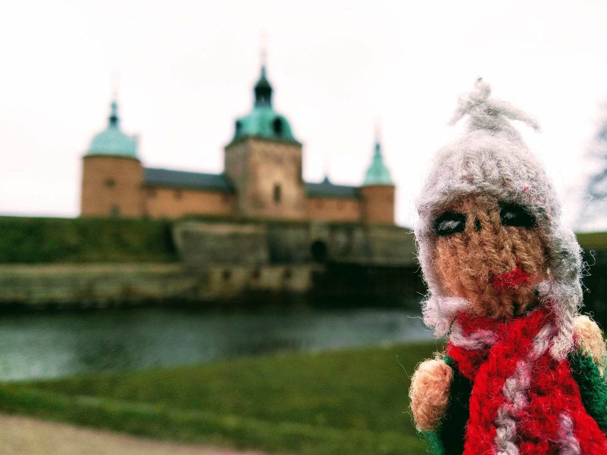 A Peruvian finger puppet braves the cold in front of the castle in Kalmar, Sweden.