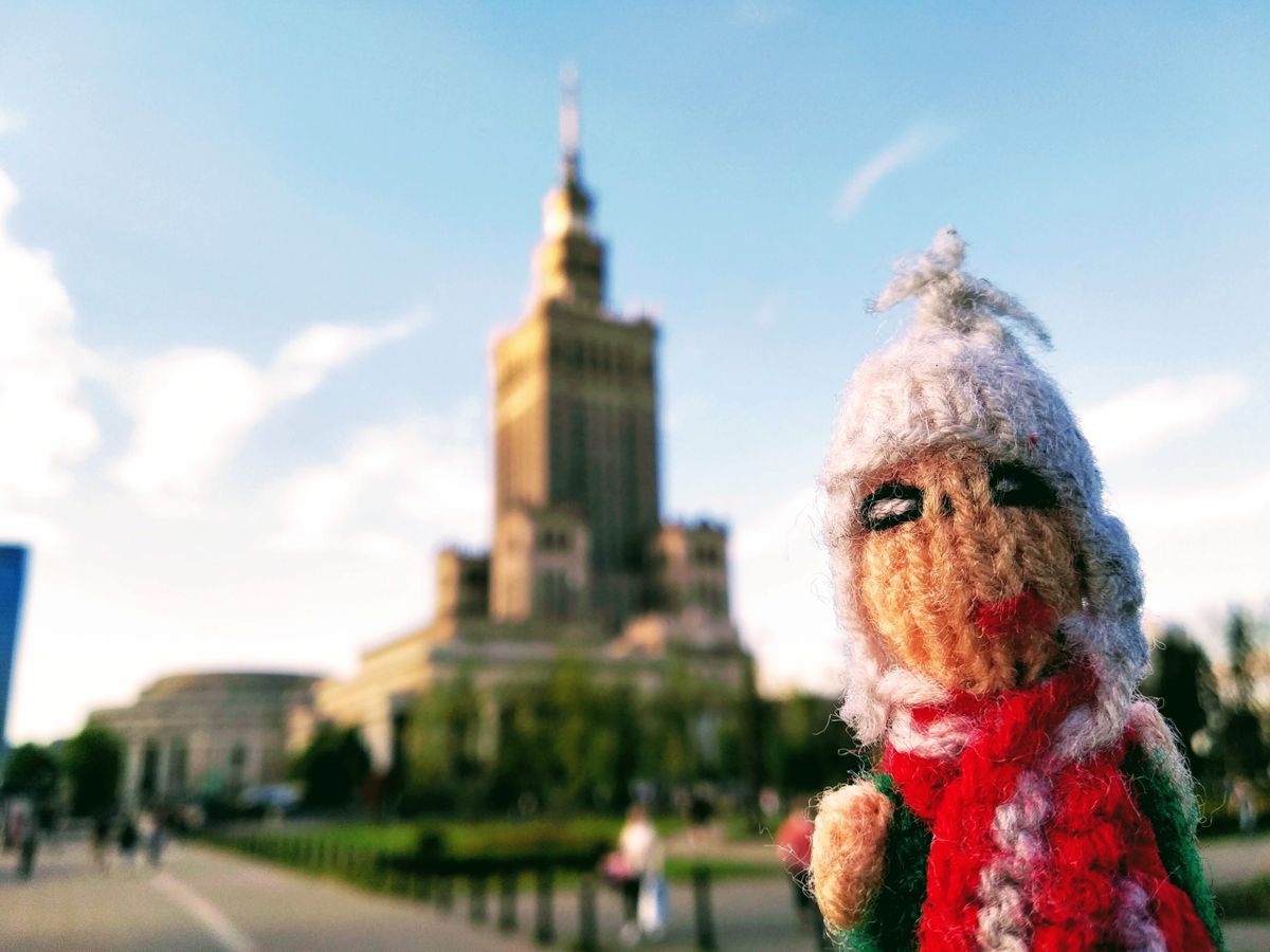 Chirpy finger puppet in front of the Palace of Culture and Science in Warsaw.