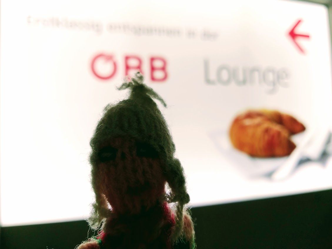 A Peruvian finger puppet looking sophisticated outside the ÖBB Lounge in Vienna Hbf.