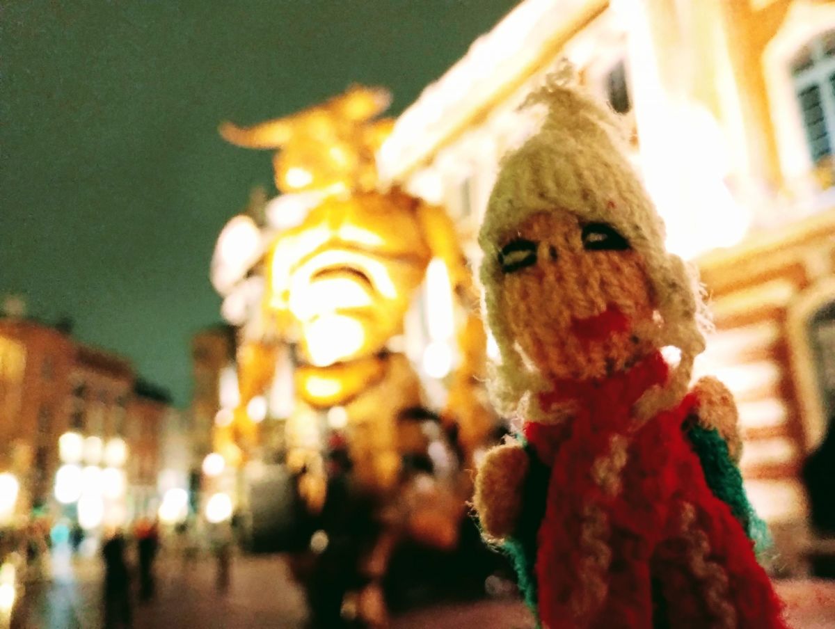 A brave finger puppet stands valiantly in front of a giant mechanical minotaur.