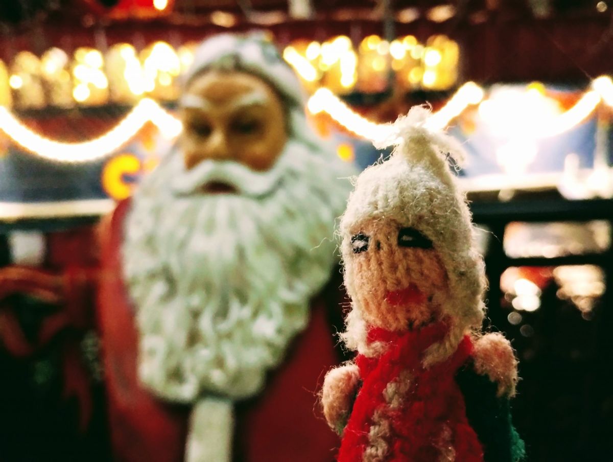 A terrified finger puppet tries to avoid eye contact with Santa for fear it might become expensive.