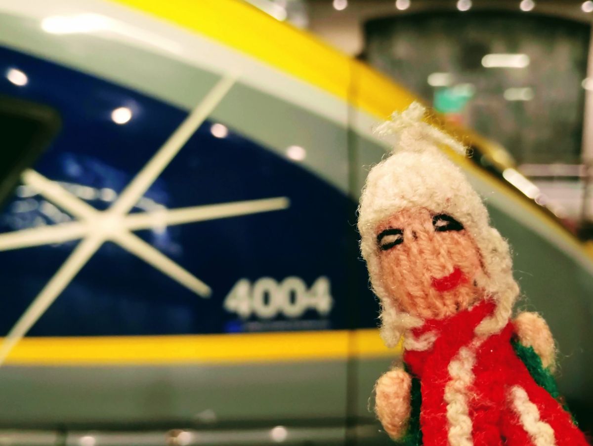Finger puppet exploring the pointy end of a Eurostar e320.