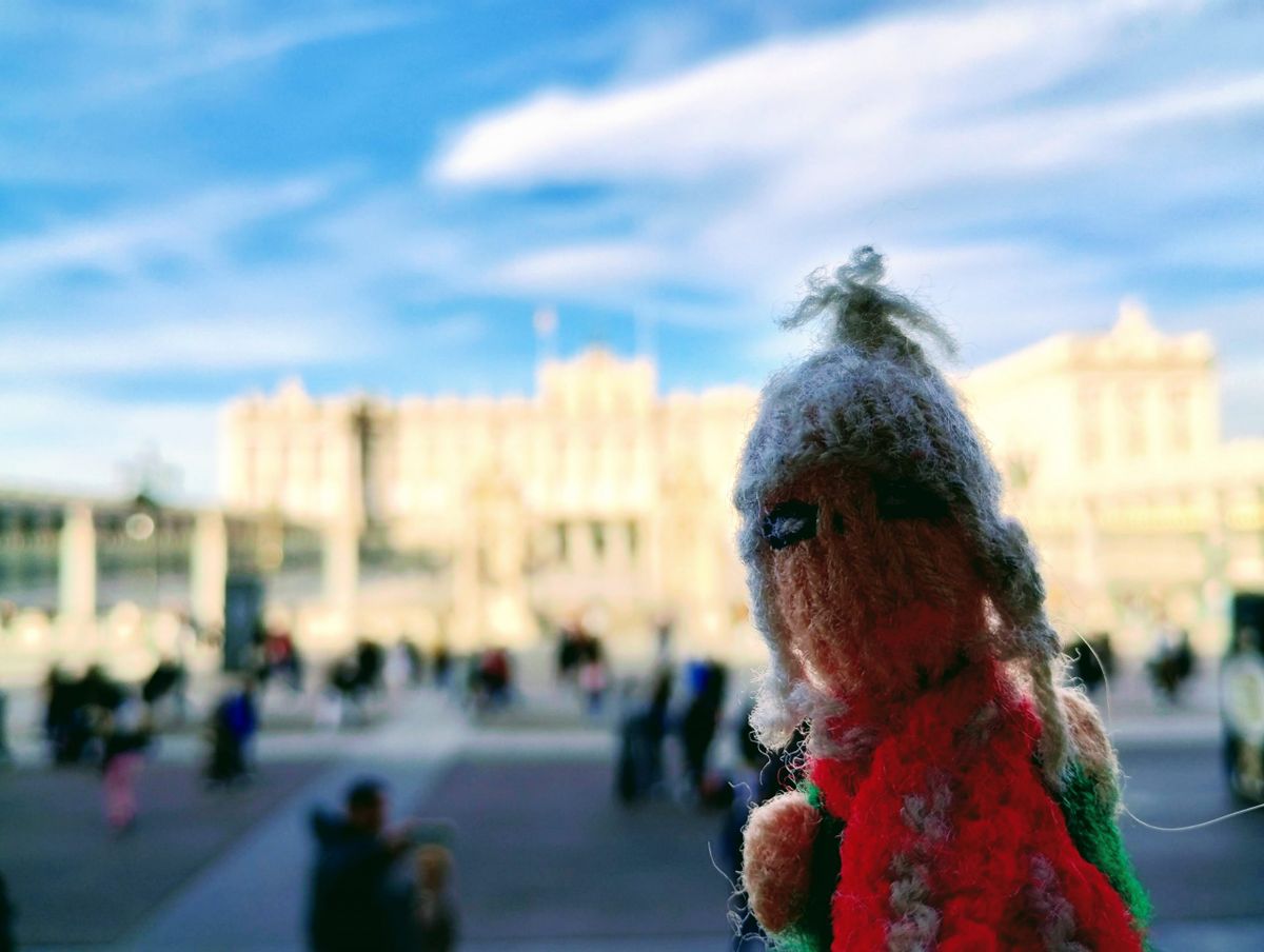 An unkempt finger puppet in front of the Royal Palace of Madrid.