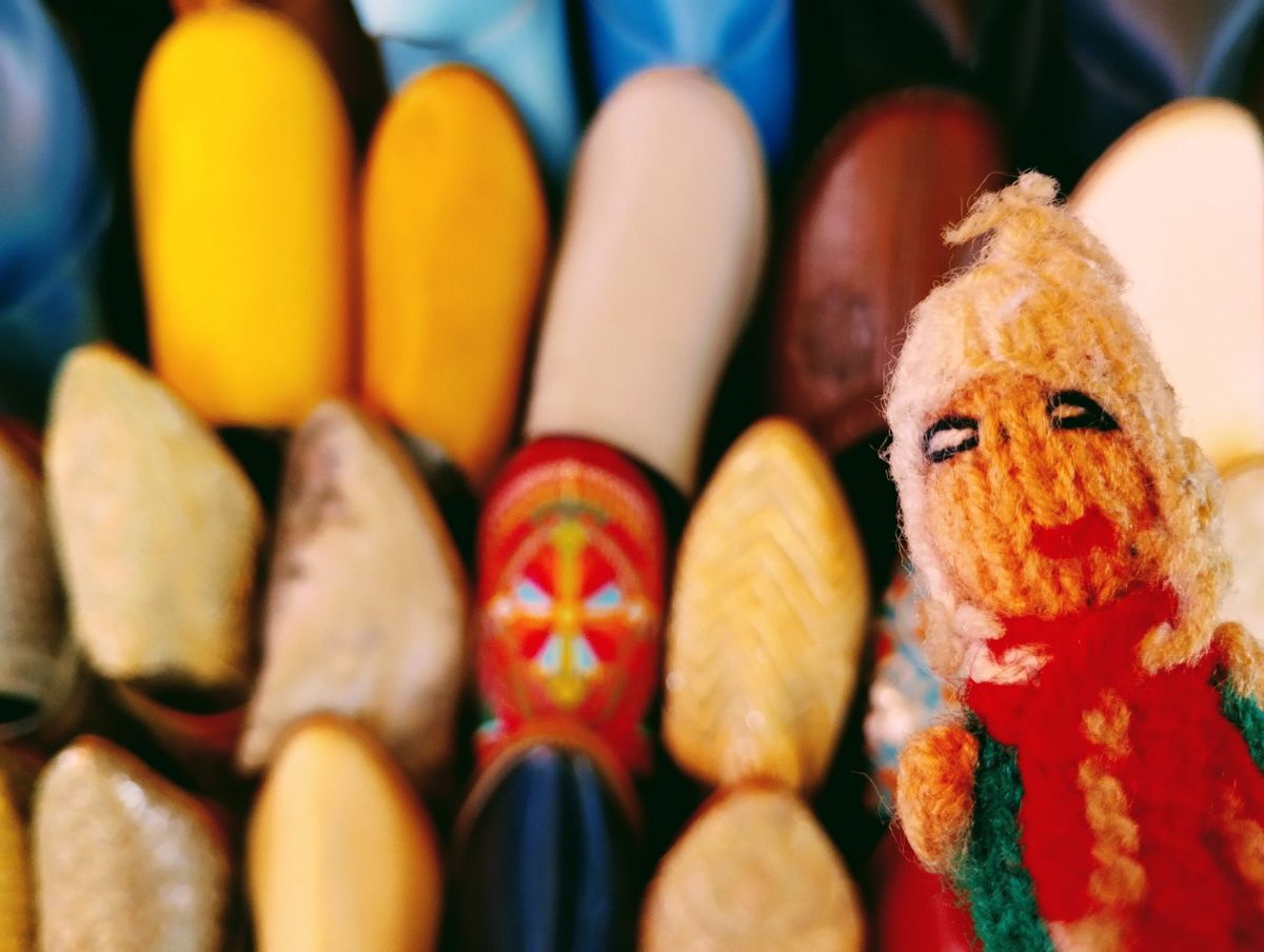 Puppet inspects a display of brightly-coloured babouches.